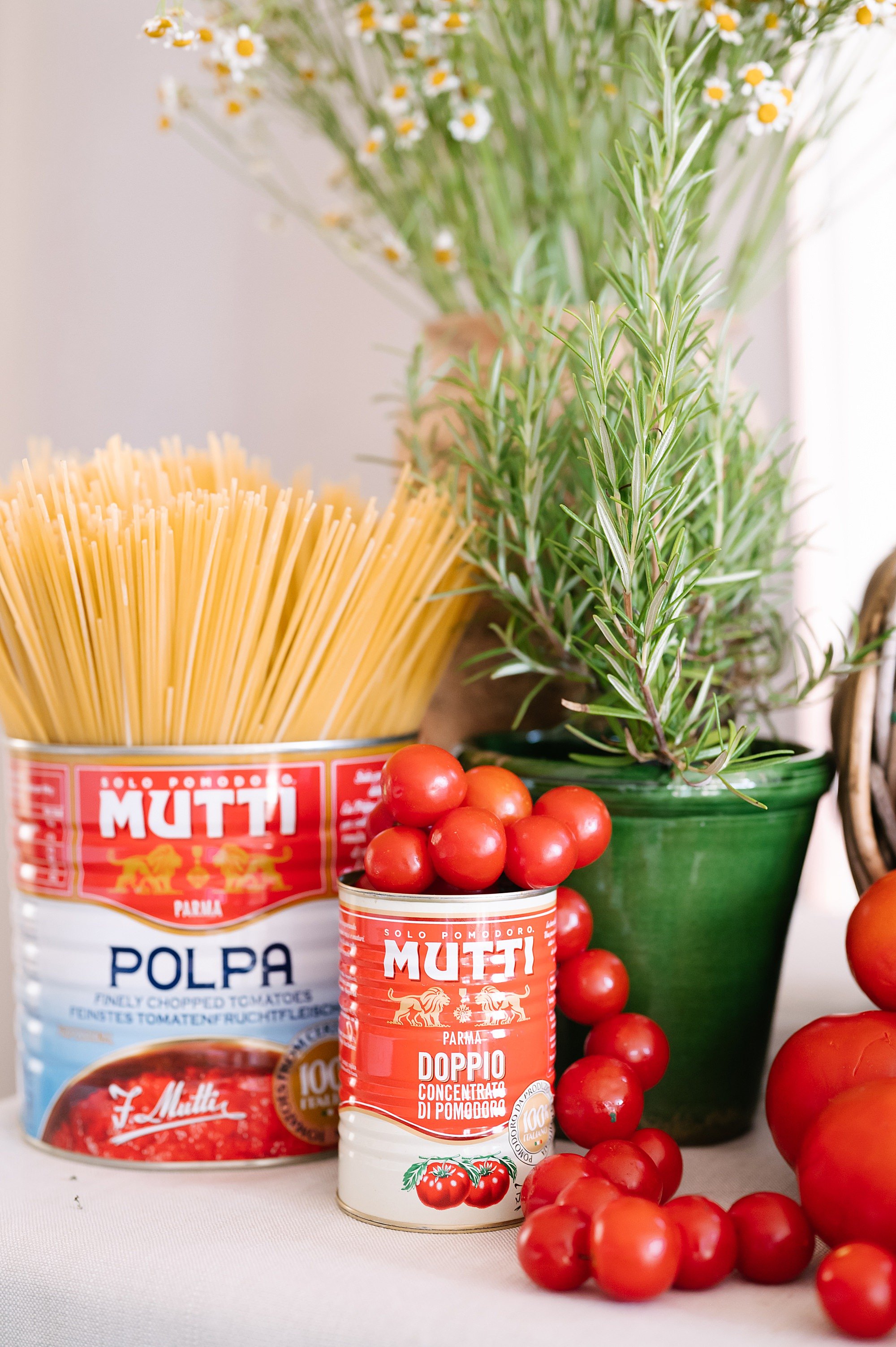 Welcome pizza party details, Italian pasta, Mutti sauce boxes and greenery