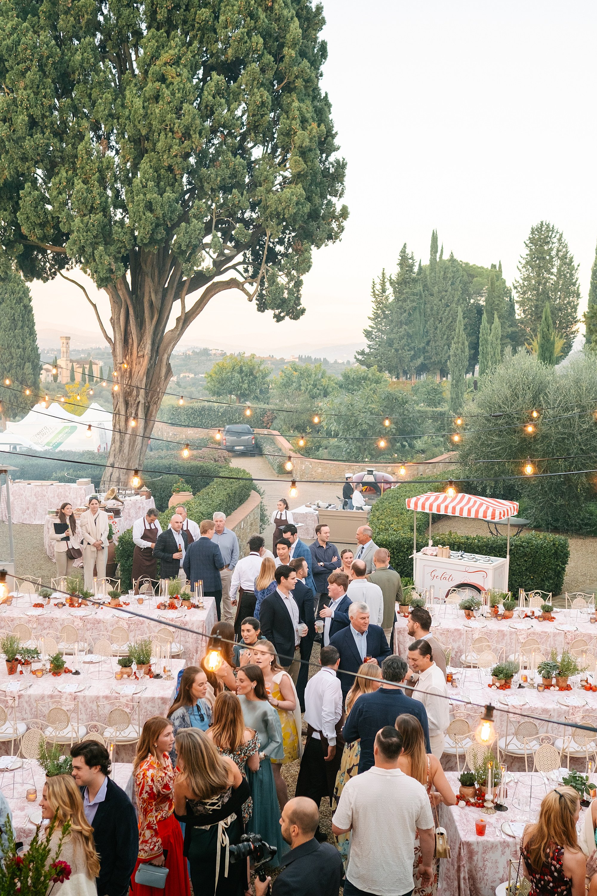 Candid wedding welcome party photography in Italy, guests enjoying drinks and food at Dimora il Ghirlandaio
