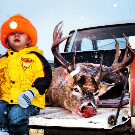 Little Bailey with Dad's monster buck