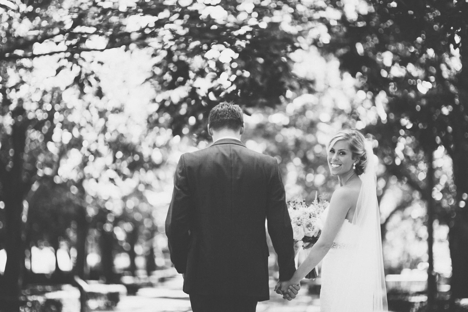 Bride and groom walking - bride looking back
