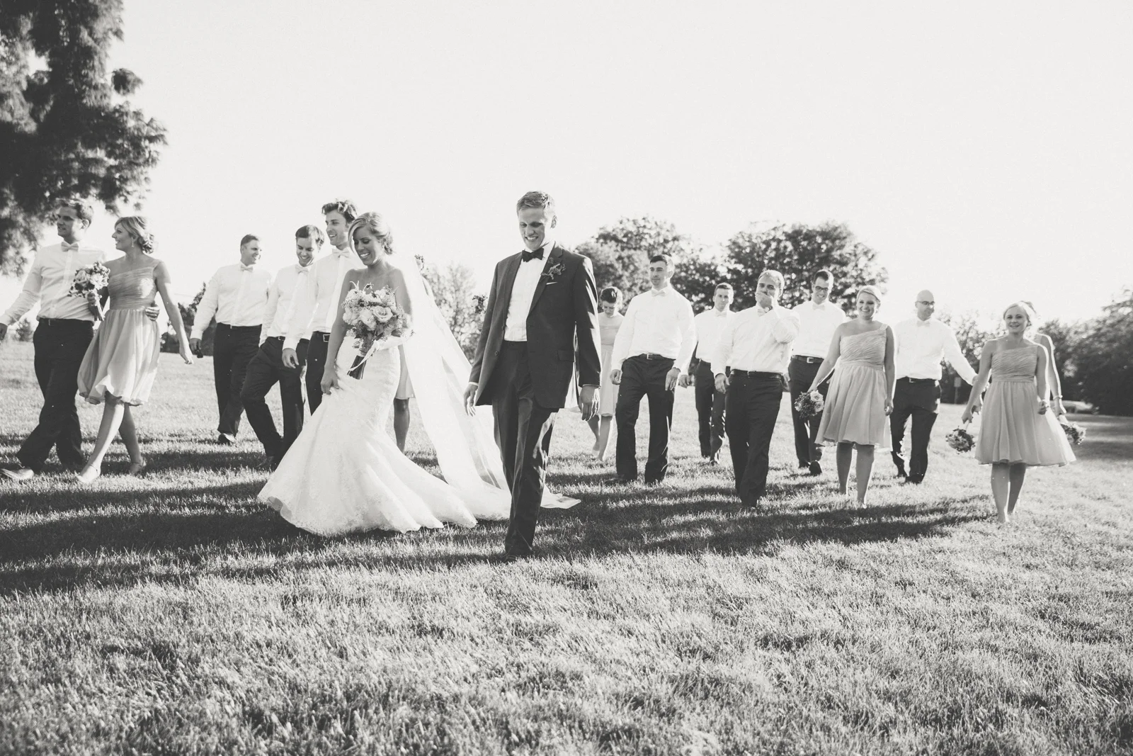 Bride and groom walking with wedding party