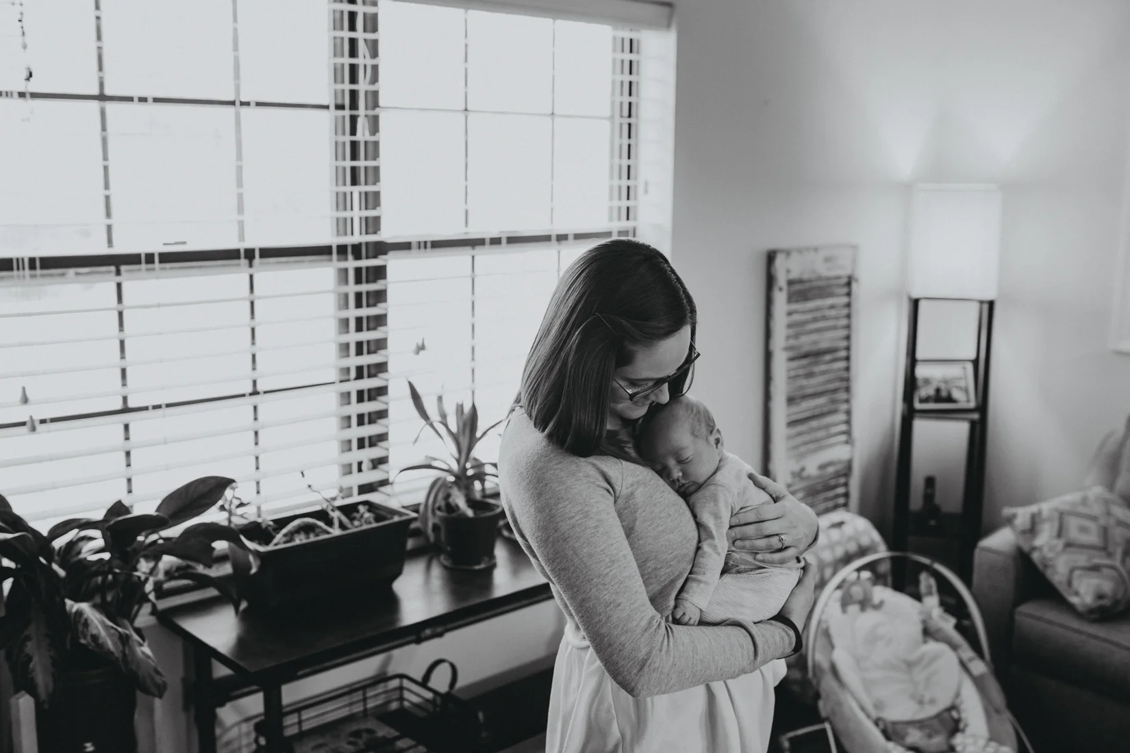 Mother holding baby in her living room