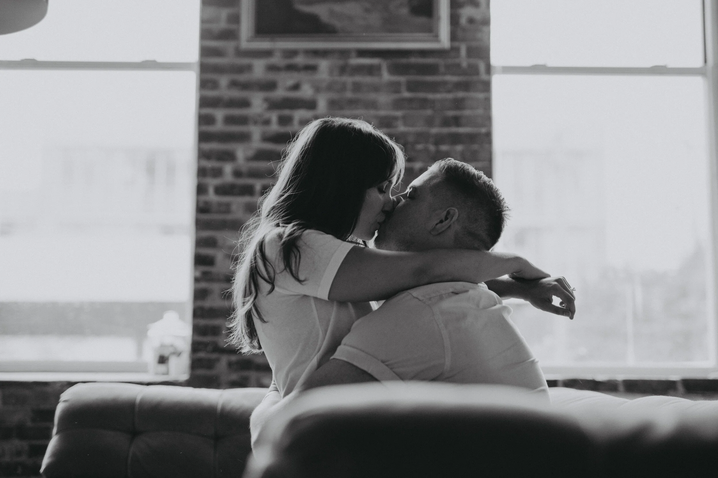 couple cuddling on couch - at home engagement session