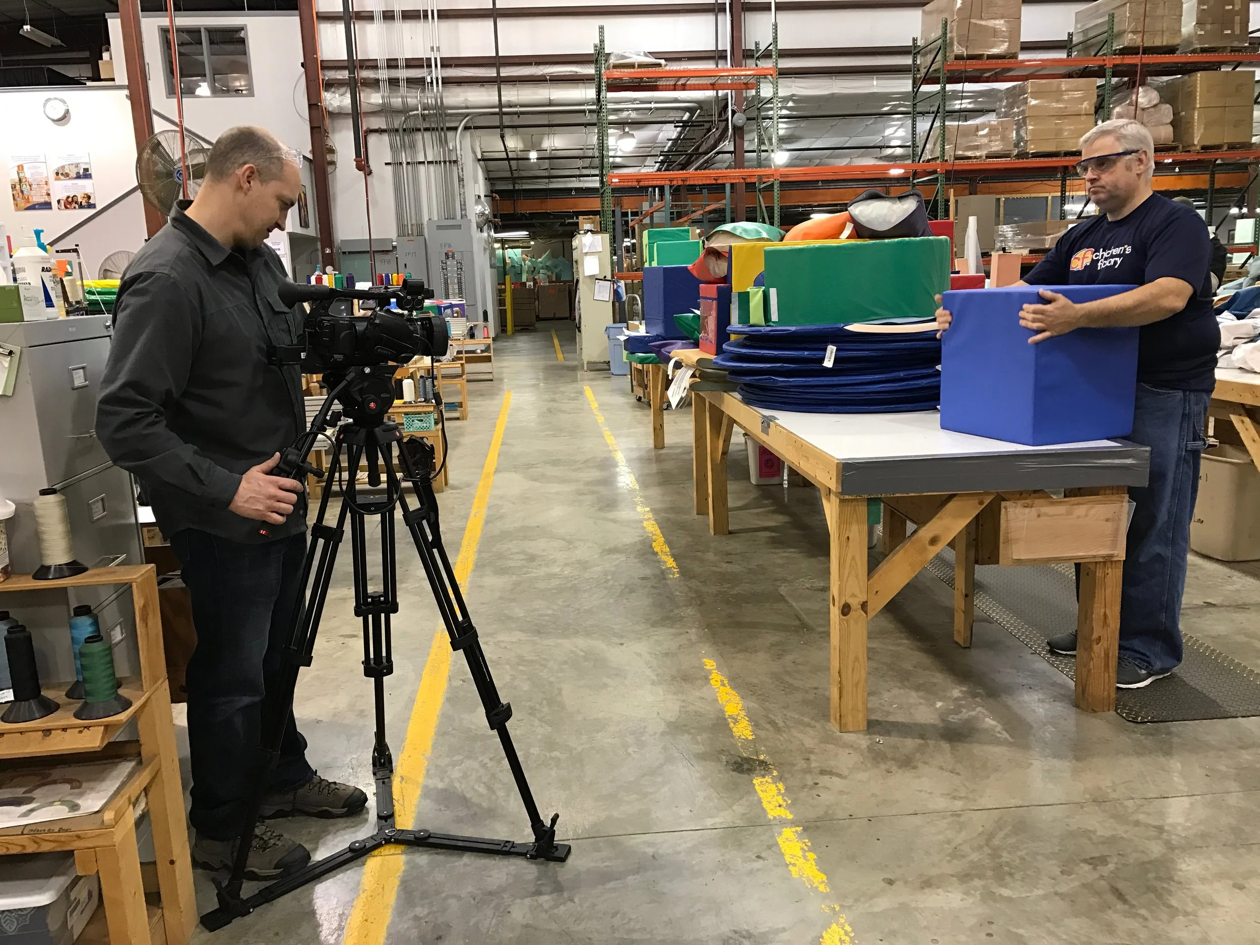 LTM at Children's Factory filming the block stuffing process.