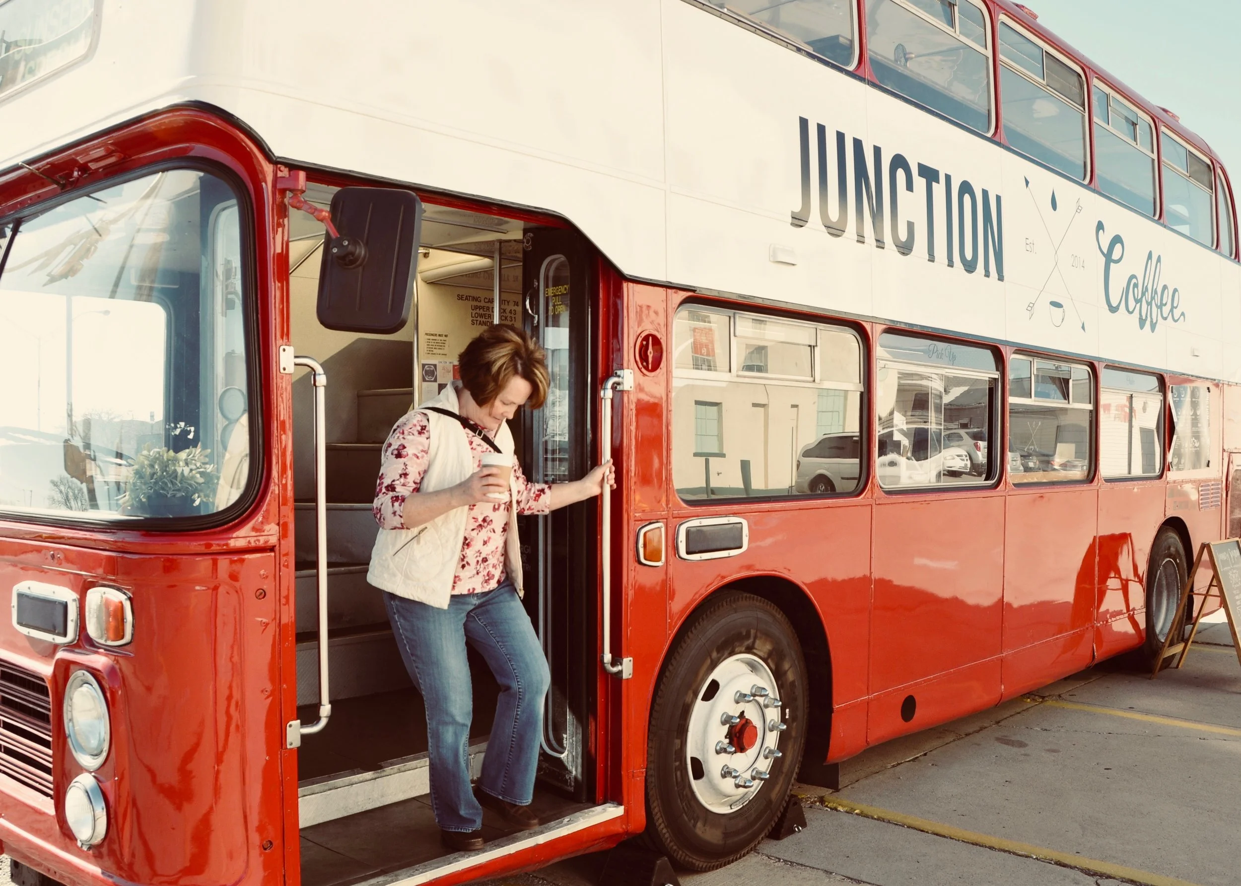 My amazing-missus enjoying a cup from the top of a double-decker bus