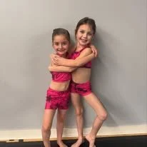 Two dancers matching a jazz pose