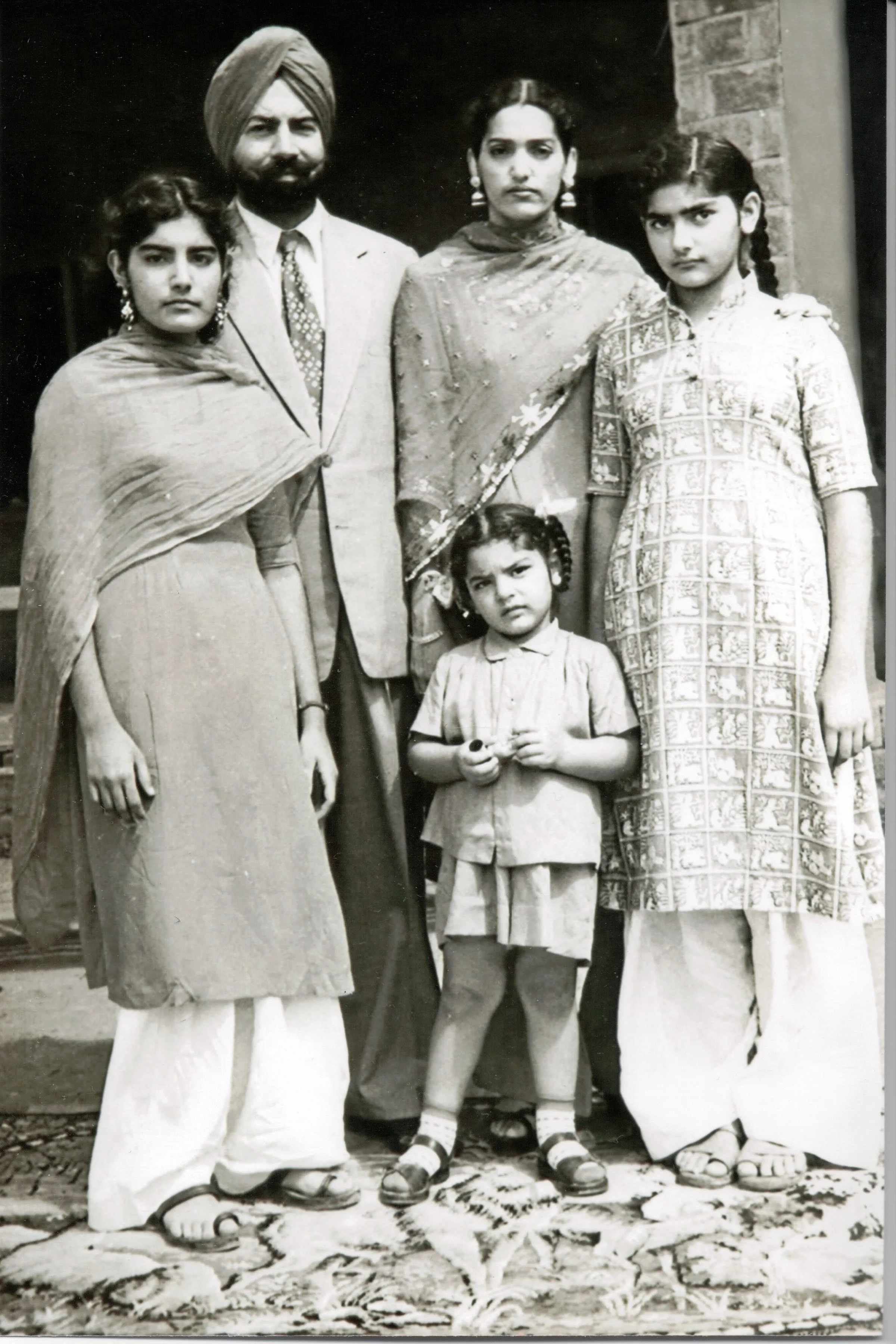 Raminder’s family, left to right: Gud, Amrik, Raminder, Boona, and in front, Babu. Delhi - 1959