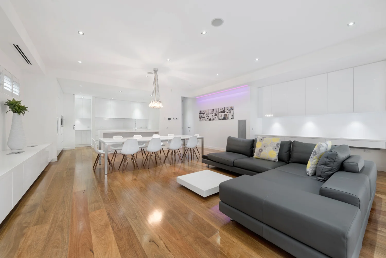 Open plan floor plan lounge, dining and kitchen with simple clean minimalist design.