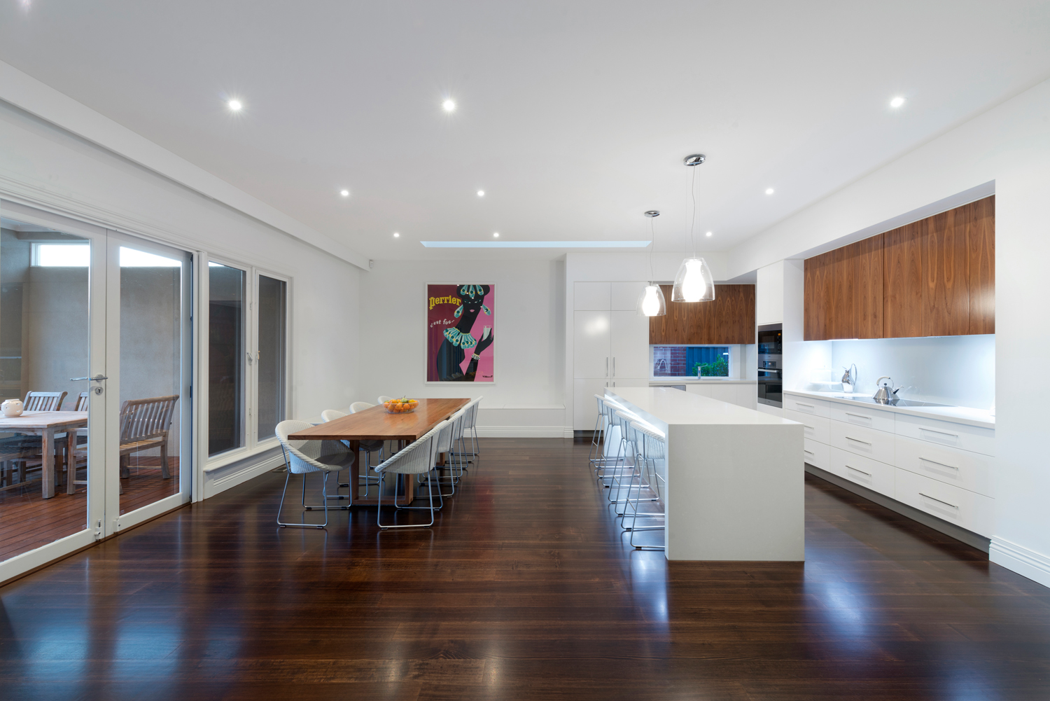 Simple retro design kitchen and dining room using wood cabinetry as highlights.