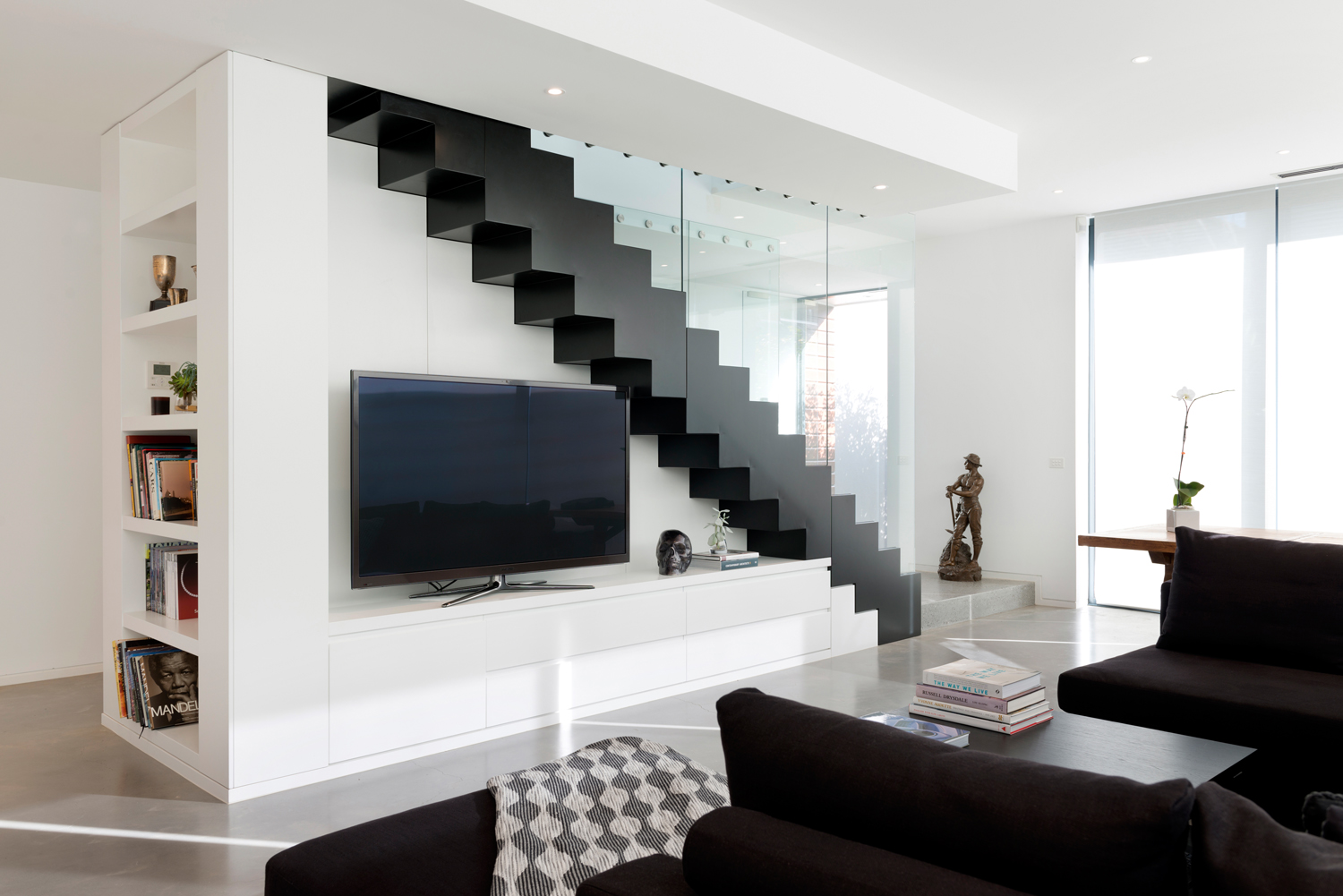Lounge with feature stair case contrast design.