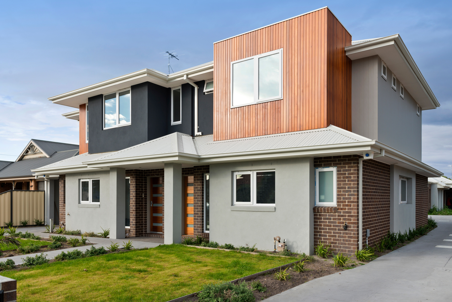 Exterior day time image of practical townhouse design.