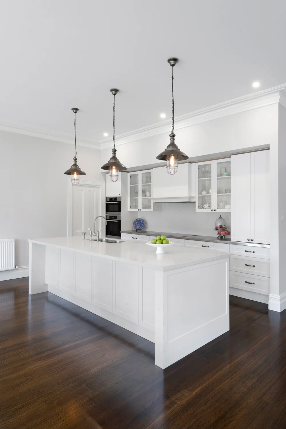 Kitchen featuring Island bench in contemporary design with traditional references.