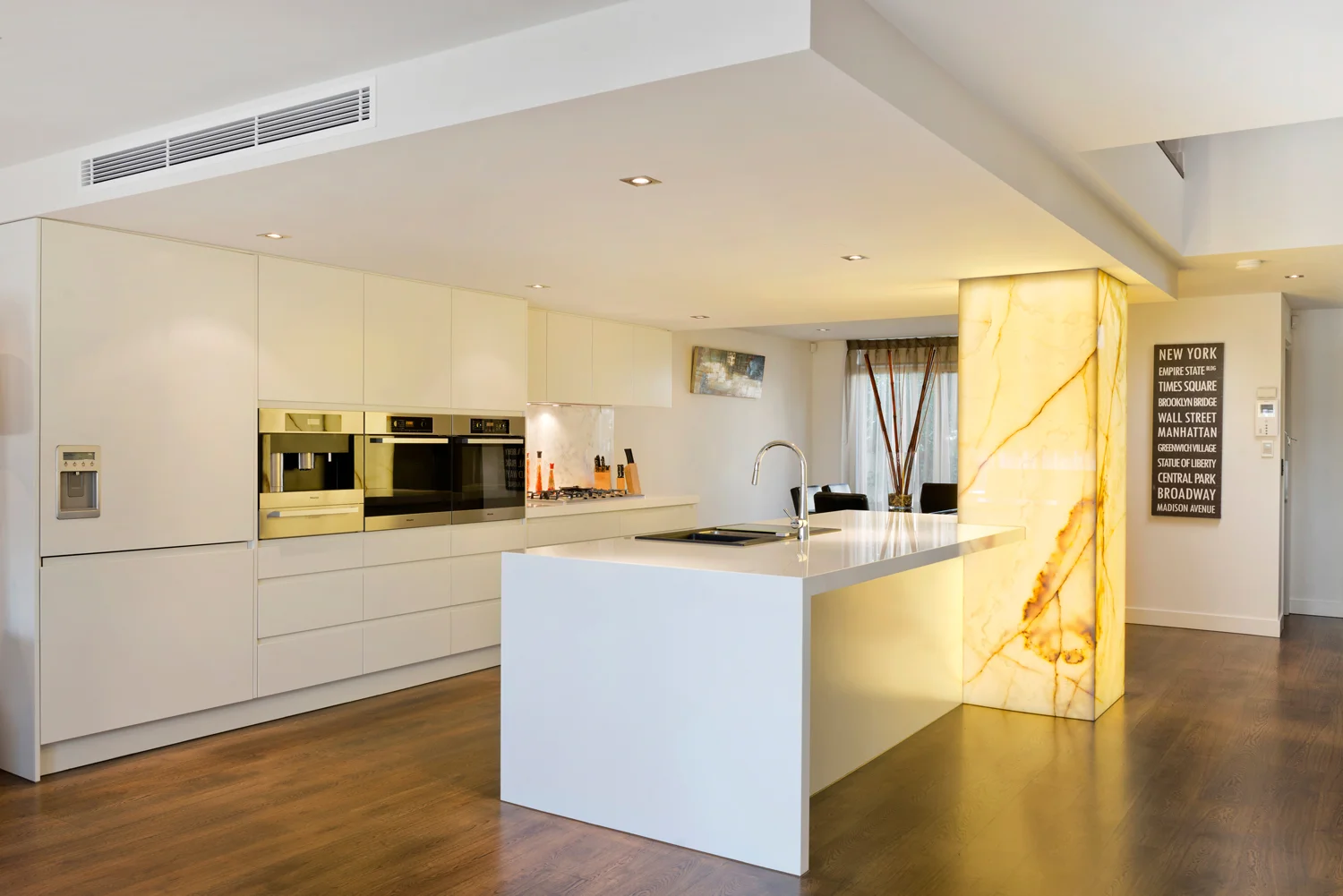 Modern kitchen with back-lit stone feature.