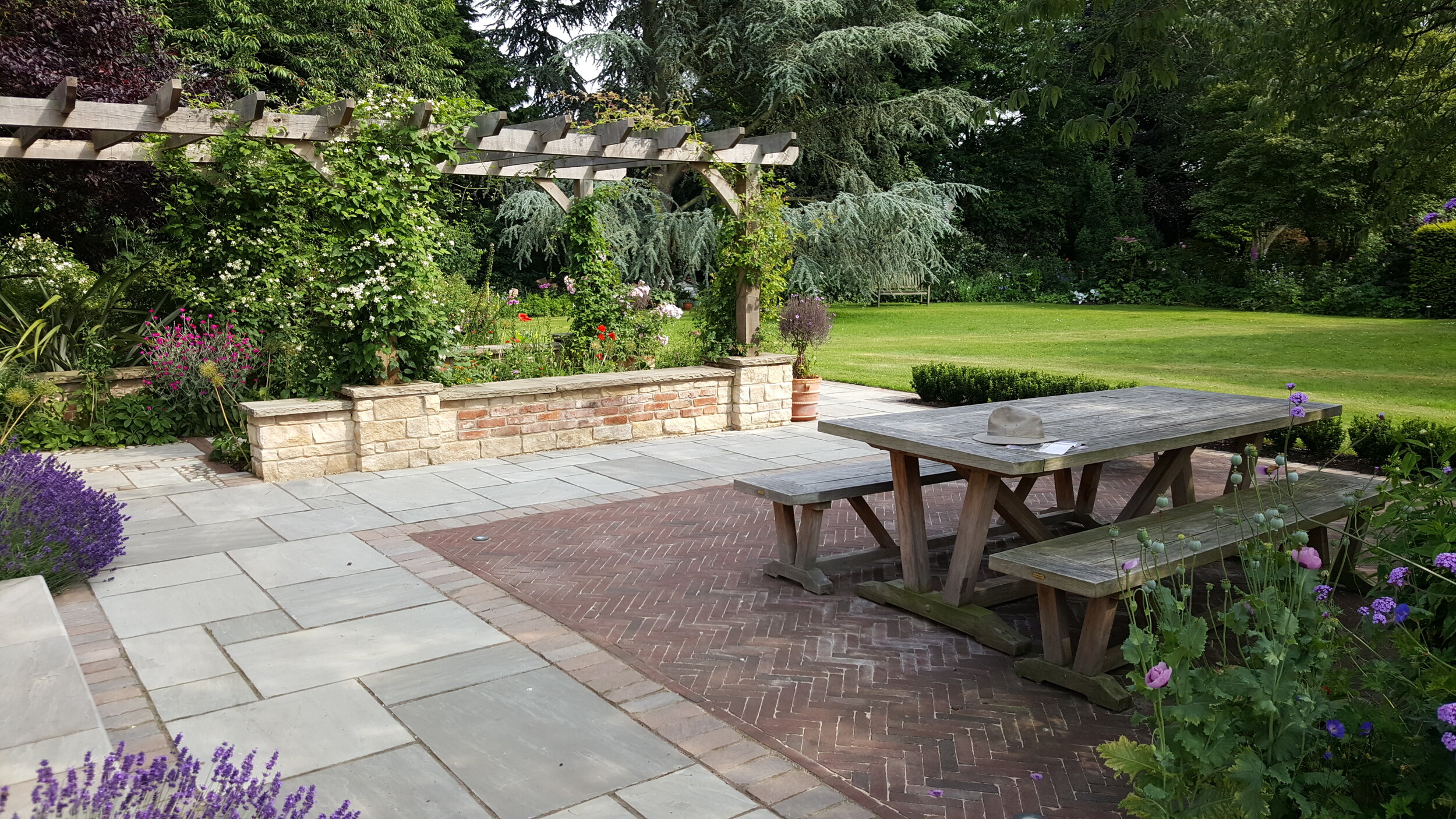 4 Garden design Lincolnshire - Garden table brick and paved terrace oak pergola.jpg