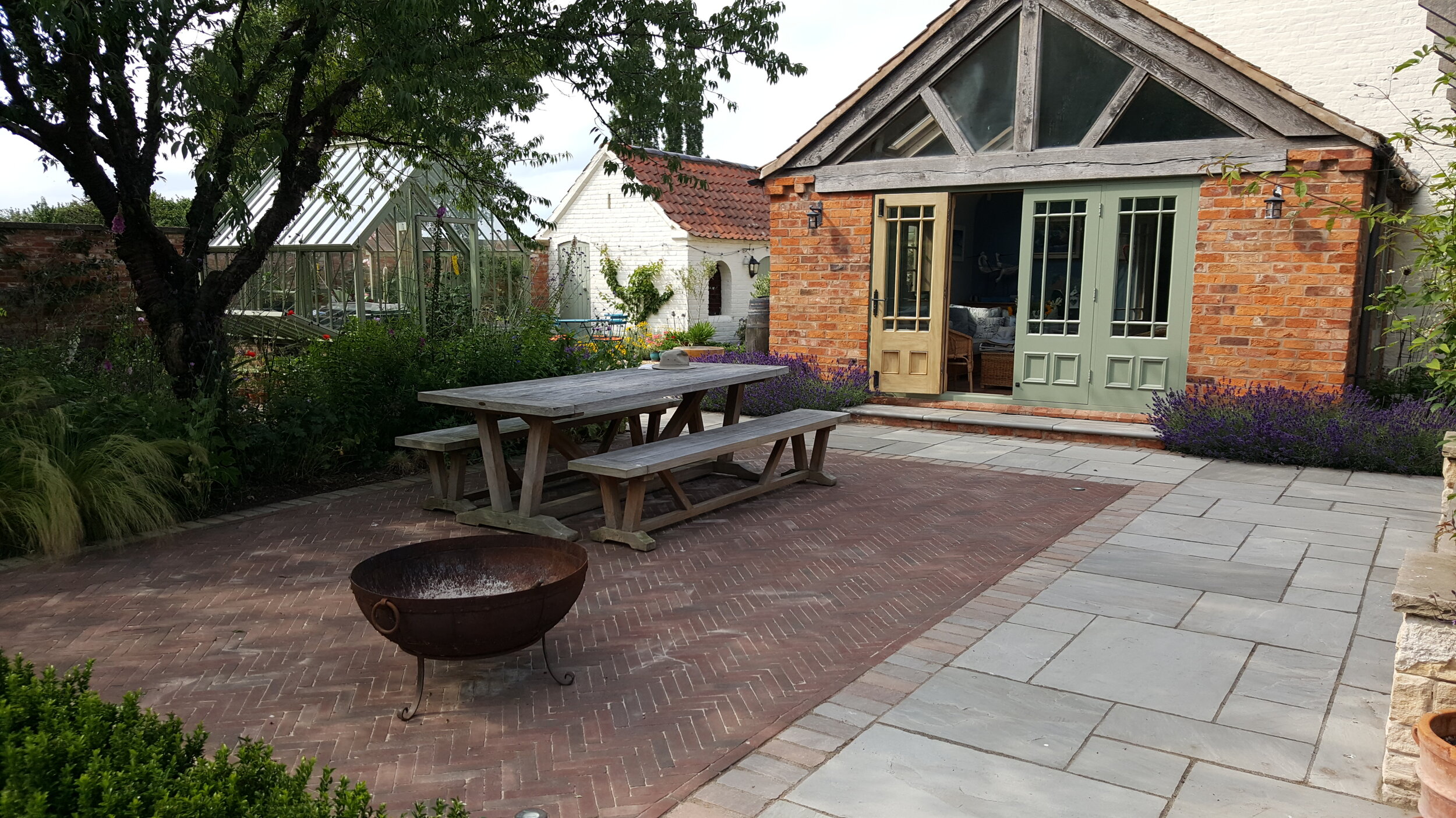 5 Garden design Lincolnshire - Fire pit garden table brick and paved terrace.jpg