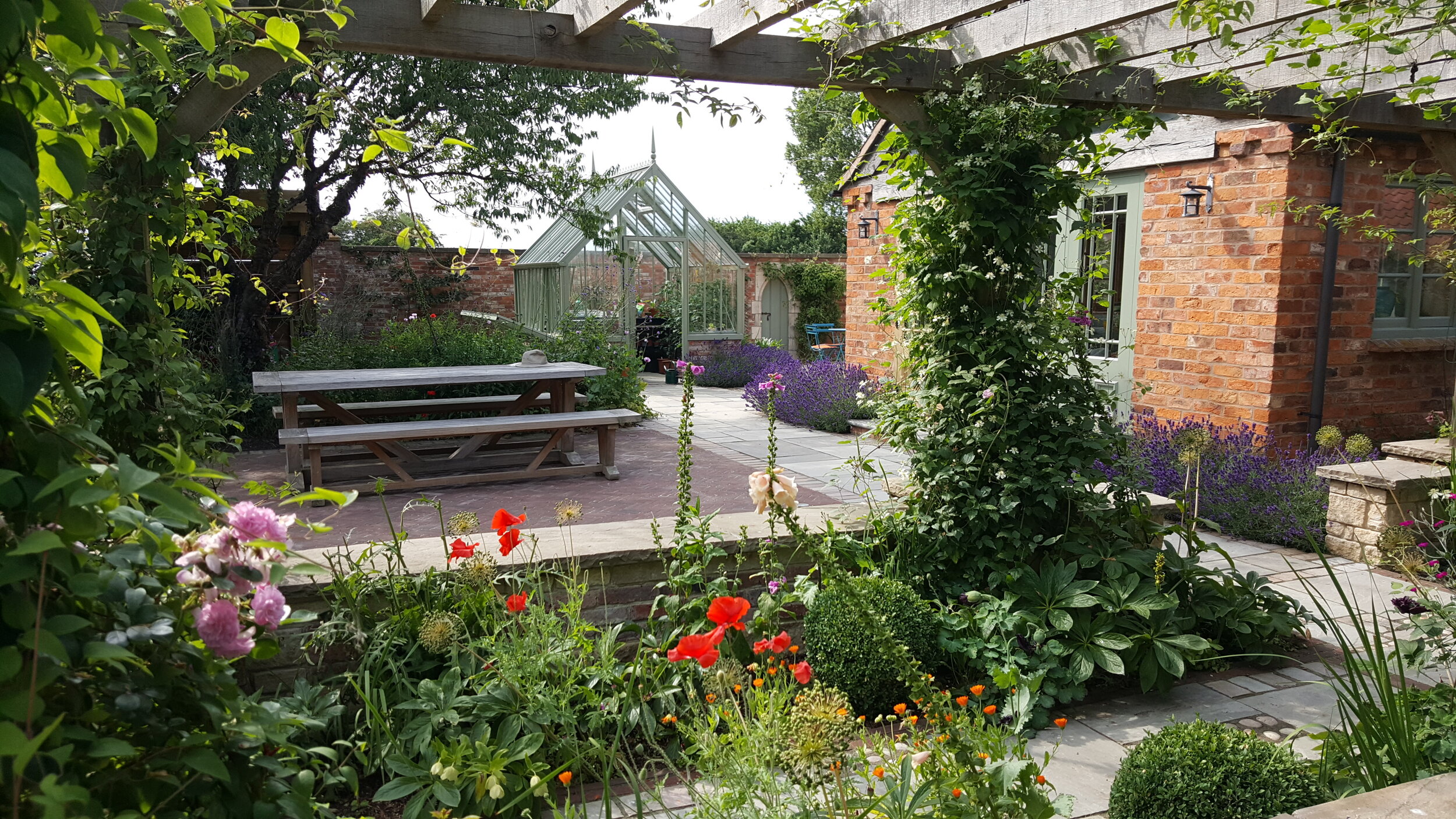 7 Garden design Lincolnshire - plant covered oak pergola garden table.jpg