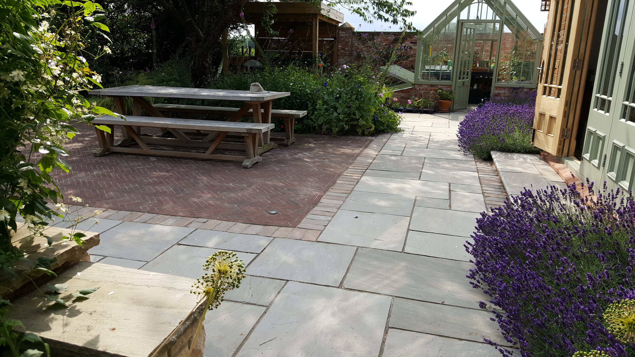 9 Garden design Lincolnshire - paved path brick terrace garden table greenhouse.jpg