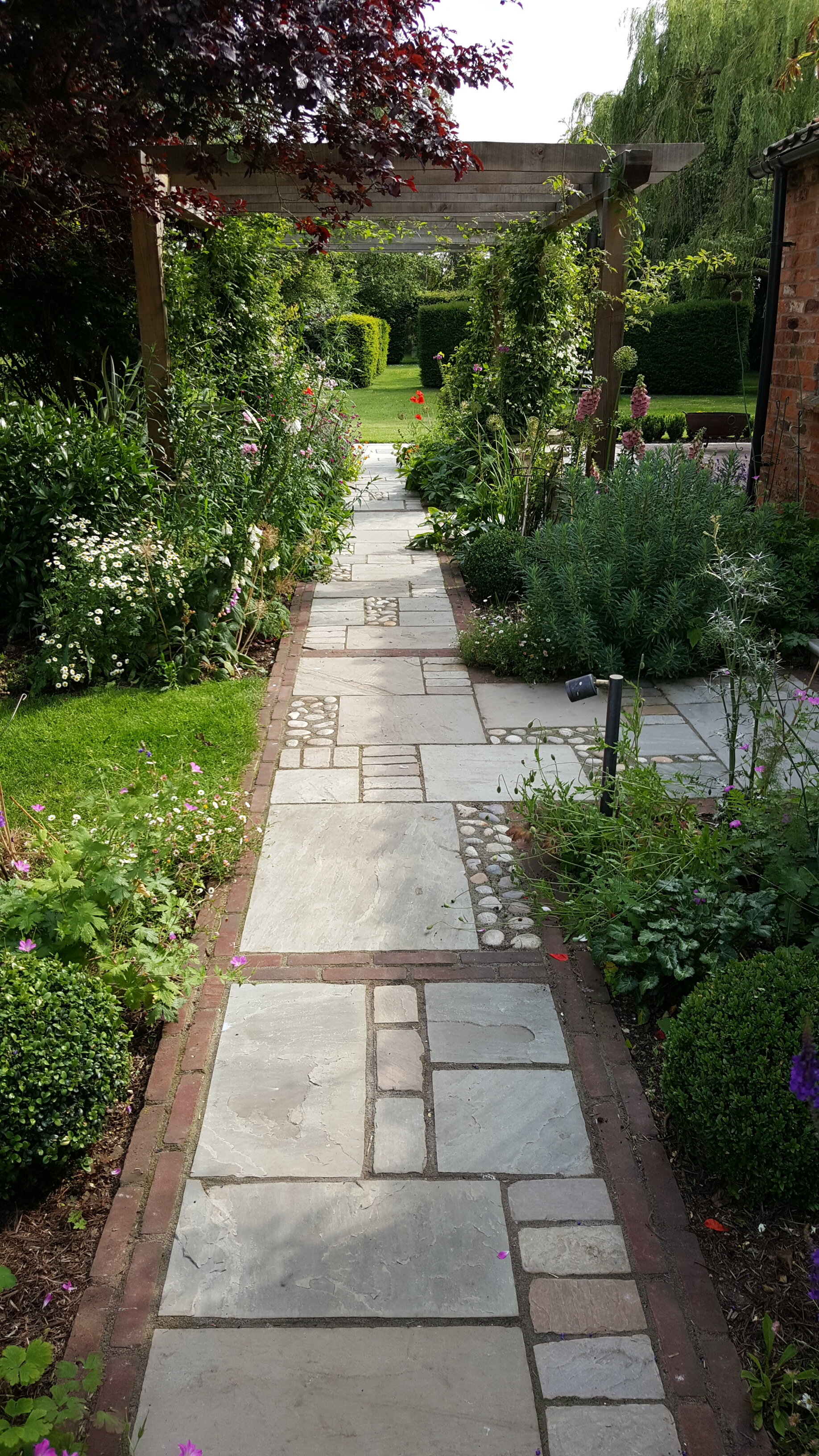 11 Garden design Lincolnshire - brick edged path mixed materials towards oak pergola.jpg