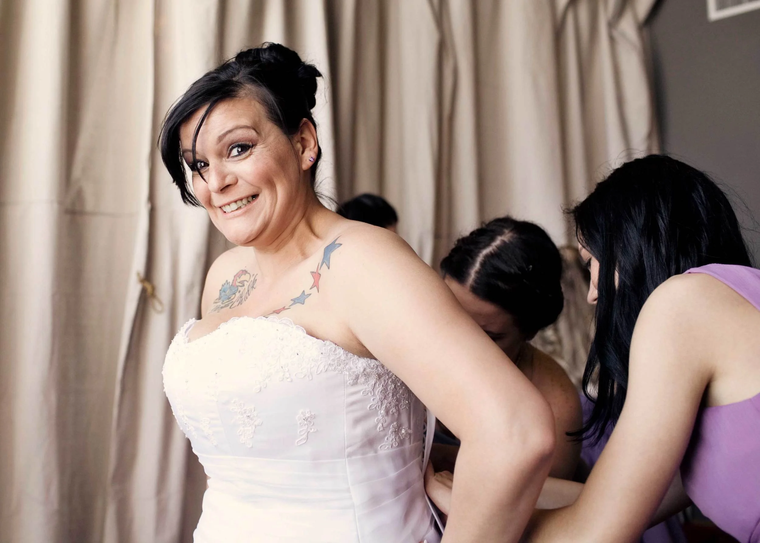 8. SO ANXIOUS WHILE OUR BRIDE'S HELPERS LACE UP HER DRESS!