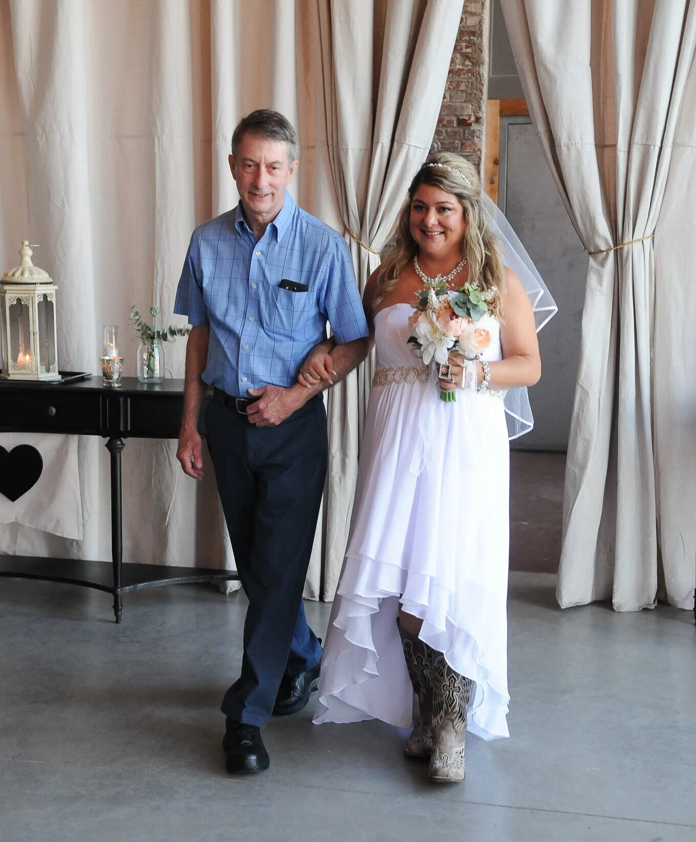 These boots were made for walking…down the aisle! Julie shows off her country-chic style as she makes her way down the aisle to her future hubby.