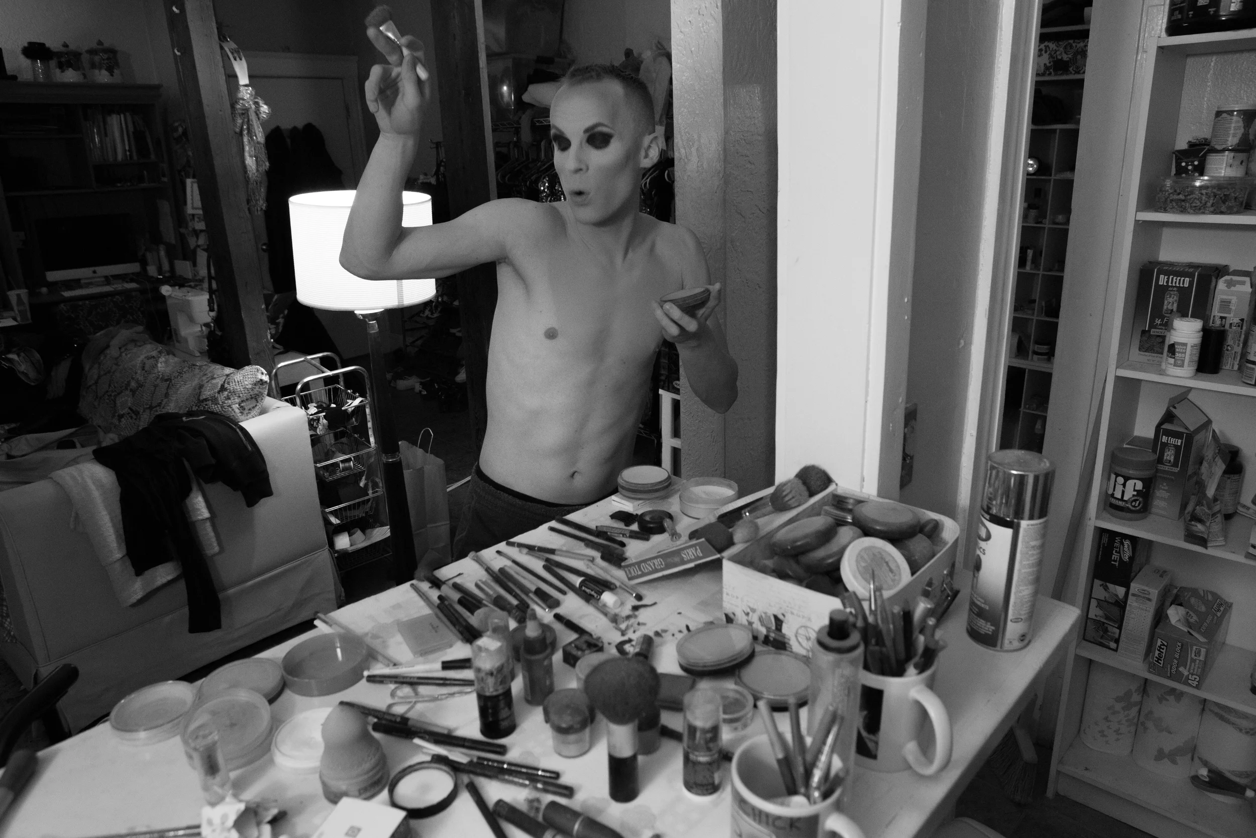 Brian McCook dances in his Broadway Street apartment in Boston, Mass. while applying makeup to dress in drag for a performance at Jaque's, a nearby bar that features entertainers in drag. Photo credit: Justin Saglio