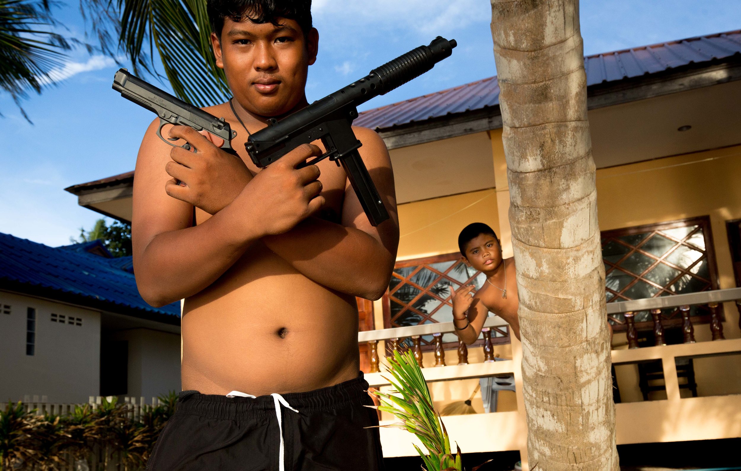 Sep. 13, 2017 - Two boys play with with toy guns In Koh Tao, Thailand.