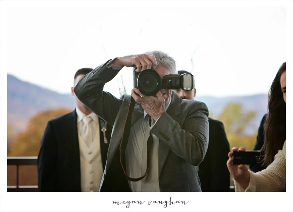  This relative is standing directly in front of the groom as the bride walks down the isle. I don't know about you, but I'd rather be staring at my groom than this relative. This image was taken by Megan Vaughan Photography and used as a perfect example for why you should have an unplugged wedding. 