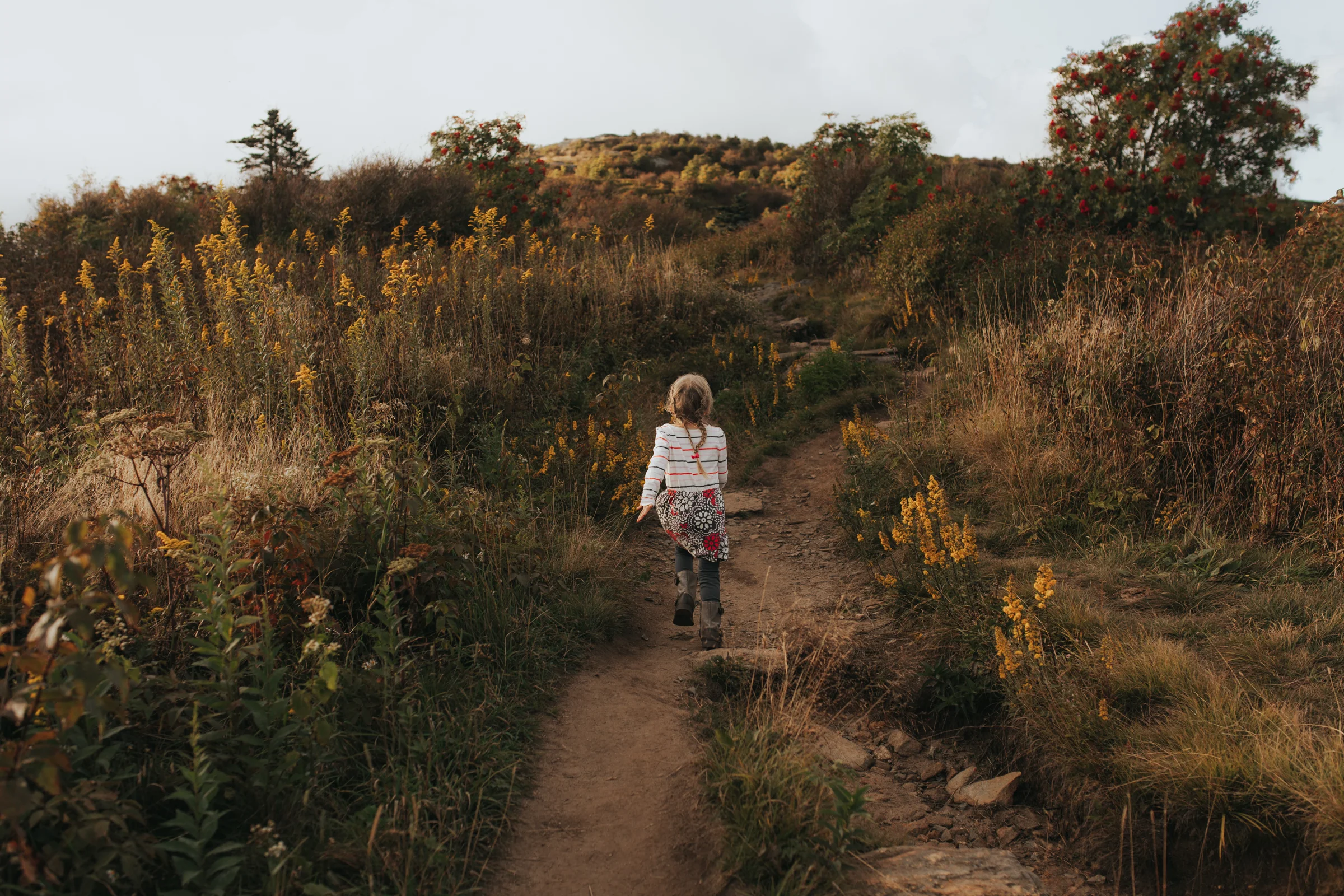 Girl runs through field on Blue Ridge parkway