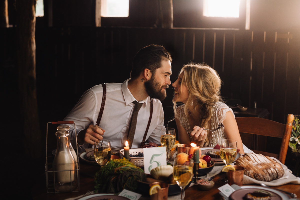 Couple shares an intimate moment during dinner on their wedding day in Asheville, North Carolina. 