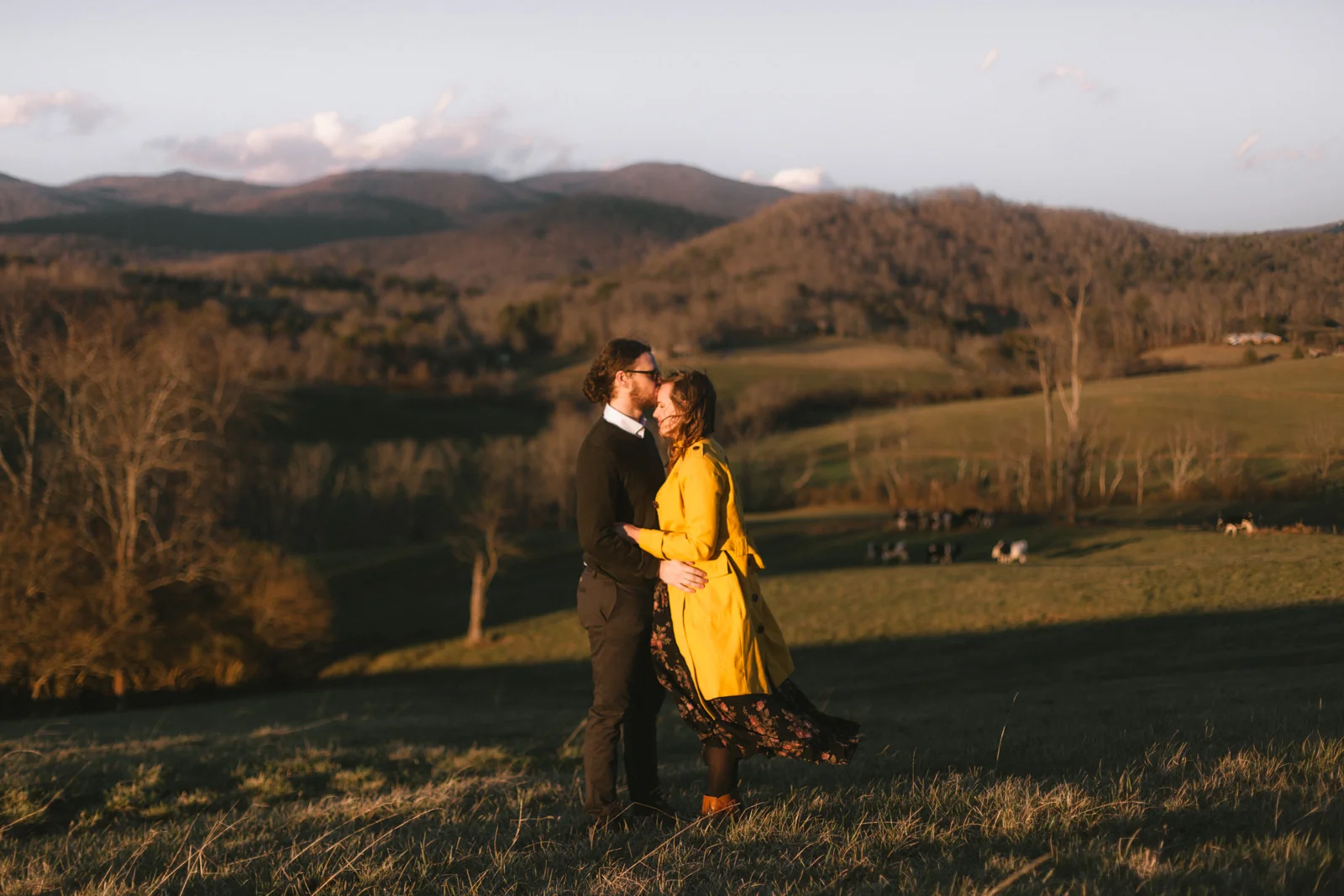 Couple embraces on a mountain in western North Carolina. 