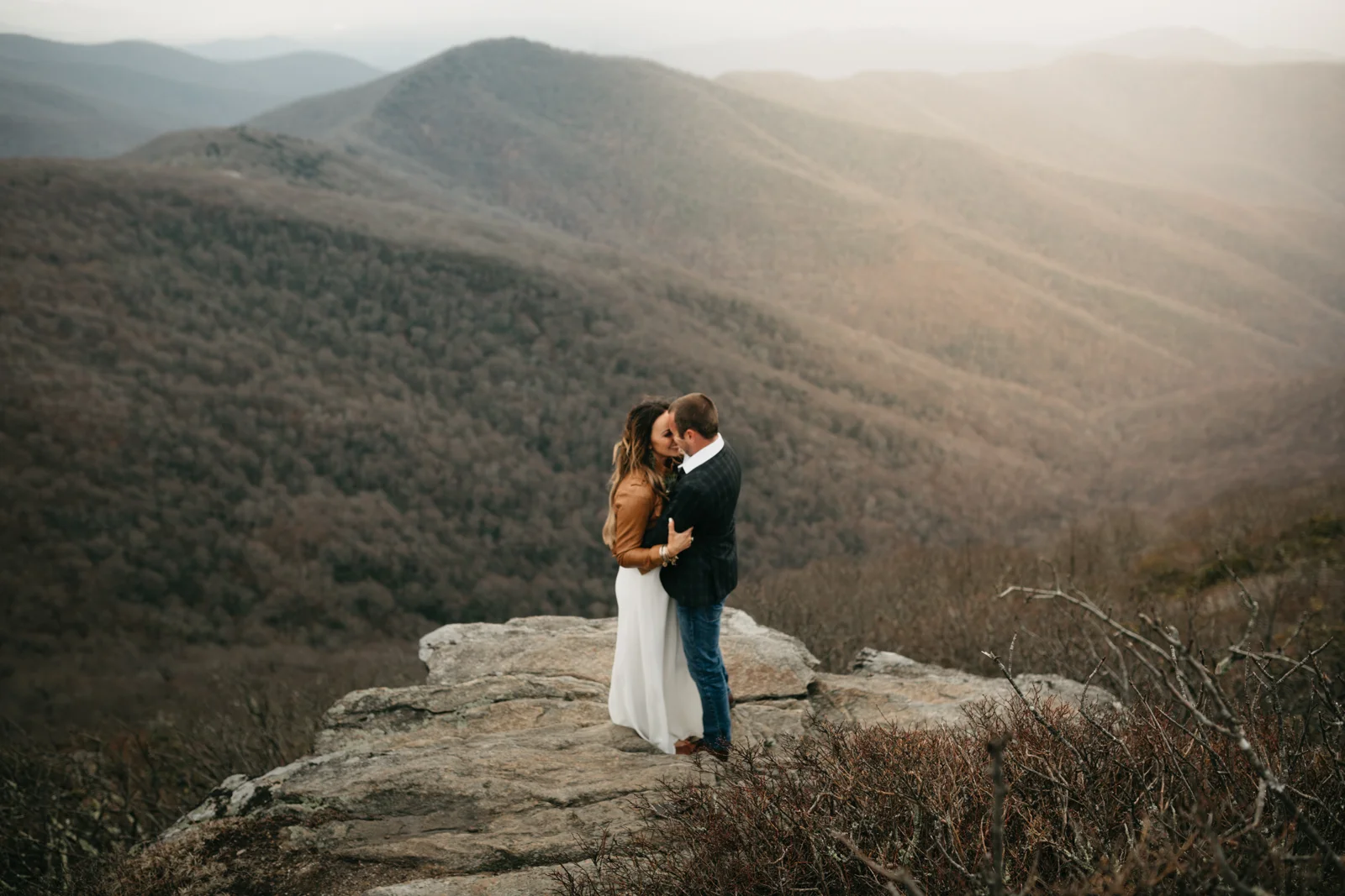 Newly married bride and groom on the rock overlook on Craggy mountain in Asheville, North Carolina.