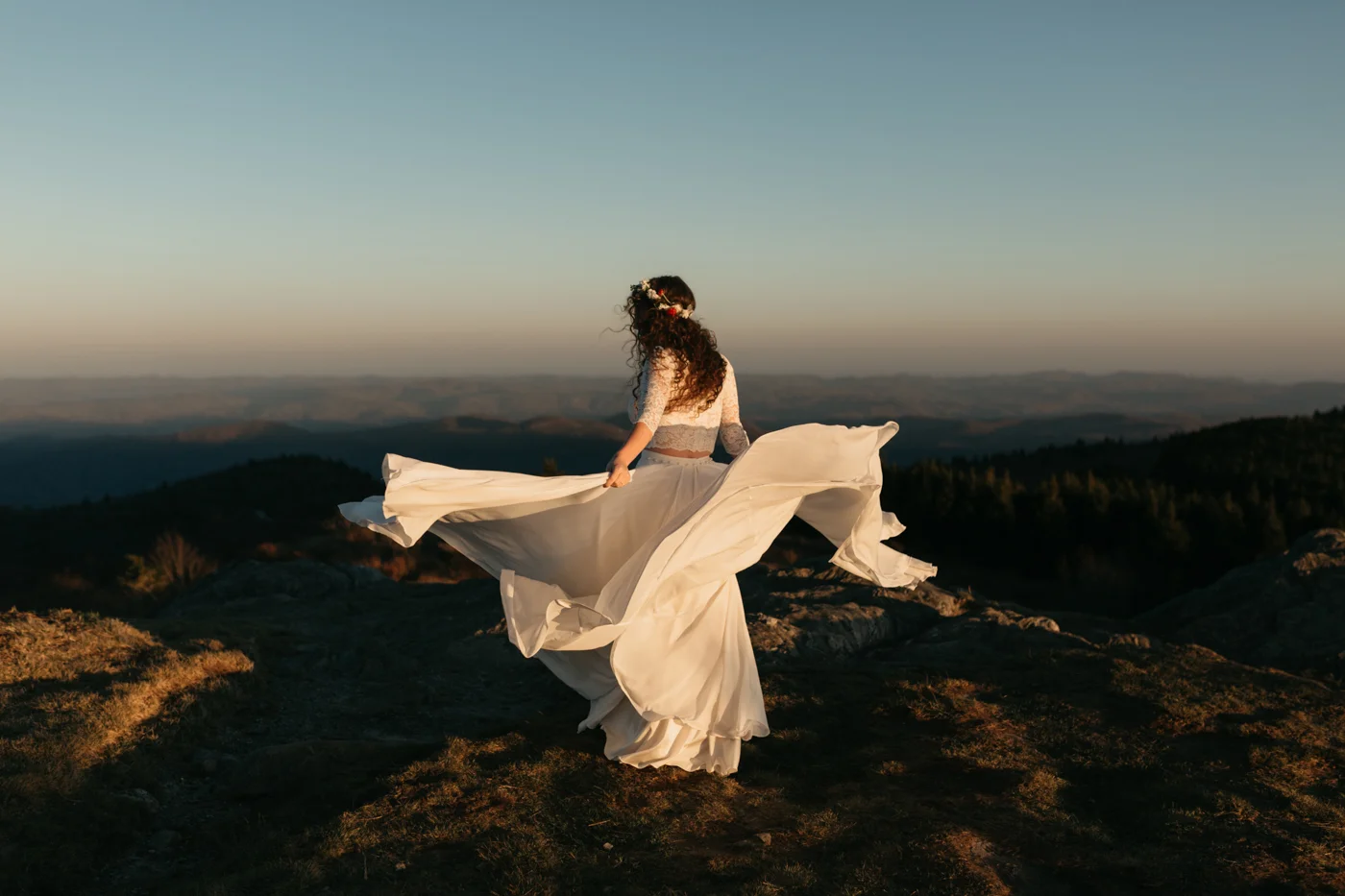 Woman in wedding dress at sunset on Black Balsam mountain in Asheville, NC.