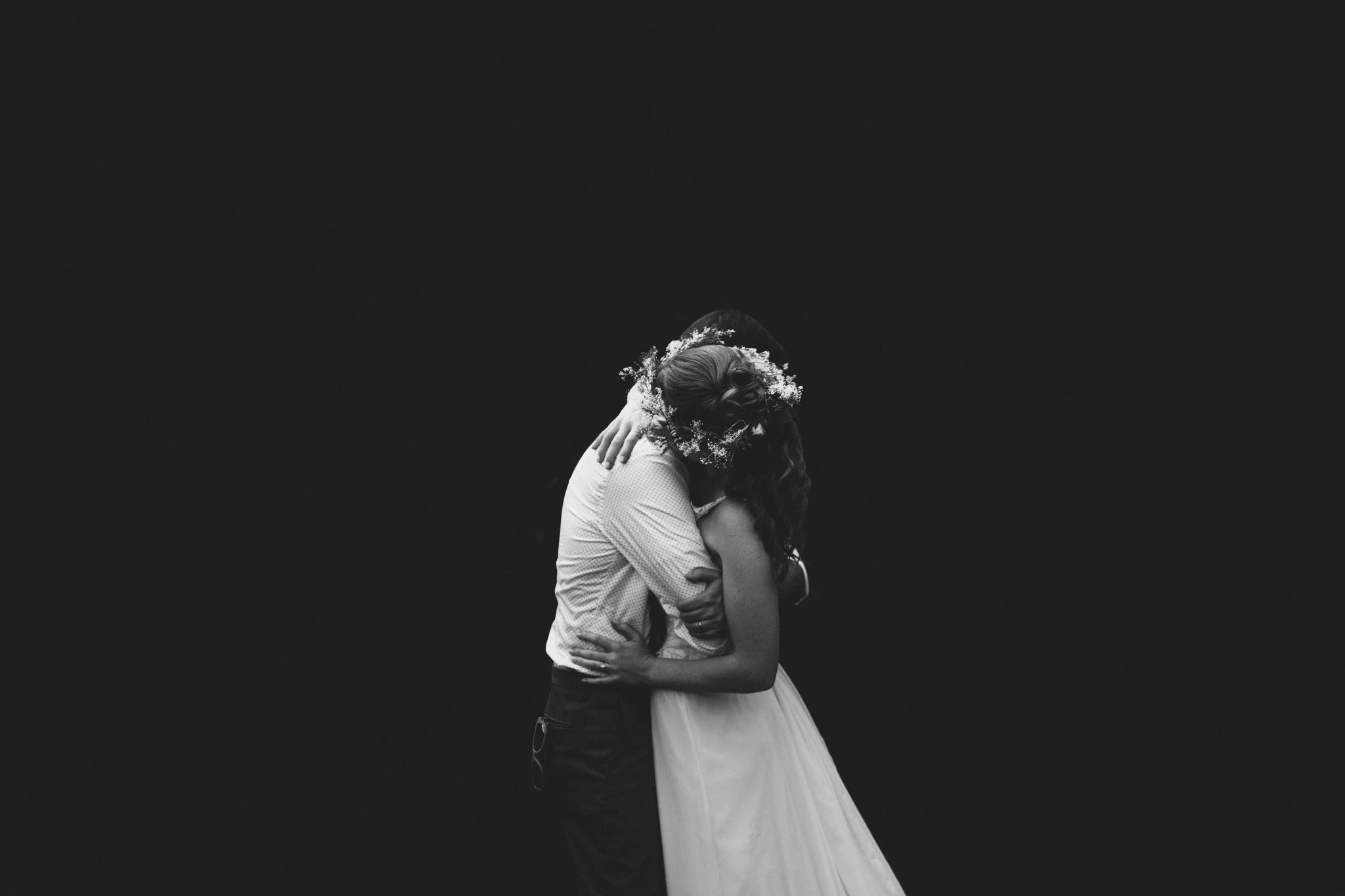 Couple embraces during photos at a destination wedding at Lake Lure Inn, NC. 