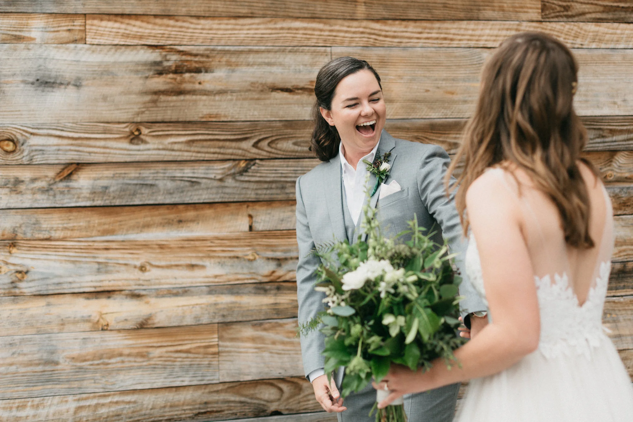 Brides share a first look on their wedding day at the Cloth Mill at Eno River. 