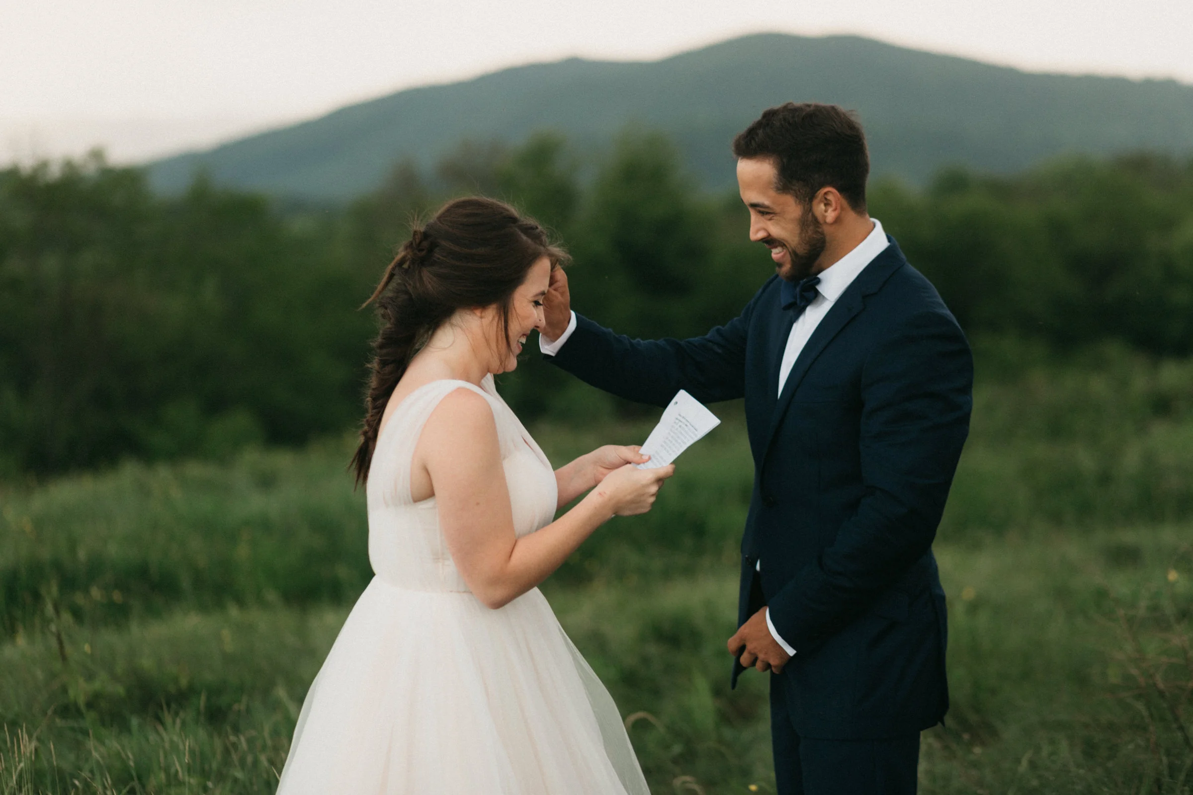 Bride and groom reading vows privately in a letter before they get married.