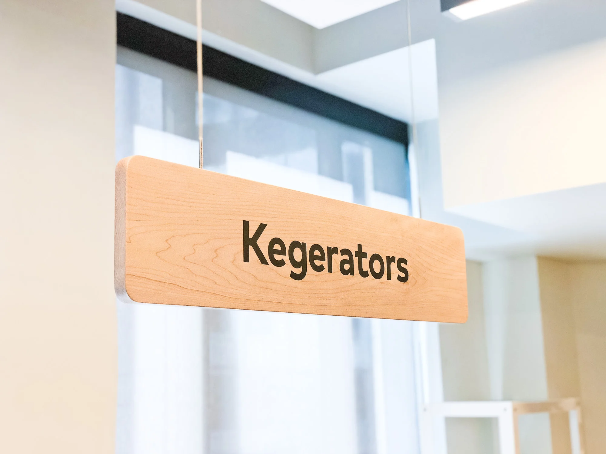 To differentiate from the neighborhood signs, we chose to ‘invert’ the palette, utilizing a birch wood texture with dark typography.
