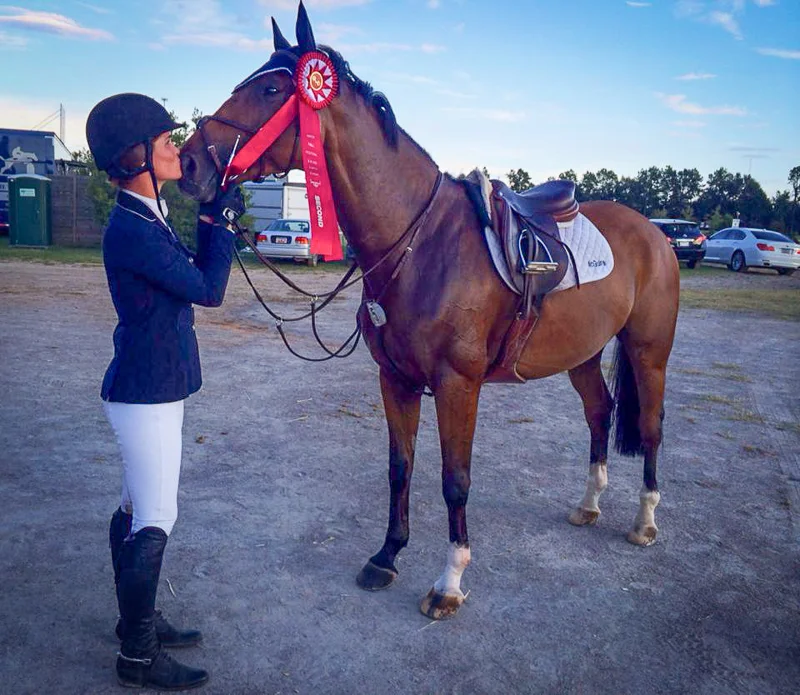 Erin McGuire thanks Kasarr for placing second in the $15,000 1.35m Open Jumper Classic.