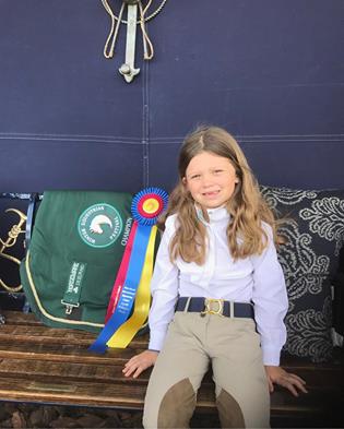Elle models her Ruespari belt and her first WEF championship ribbon and cooler.
