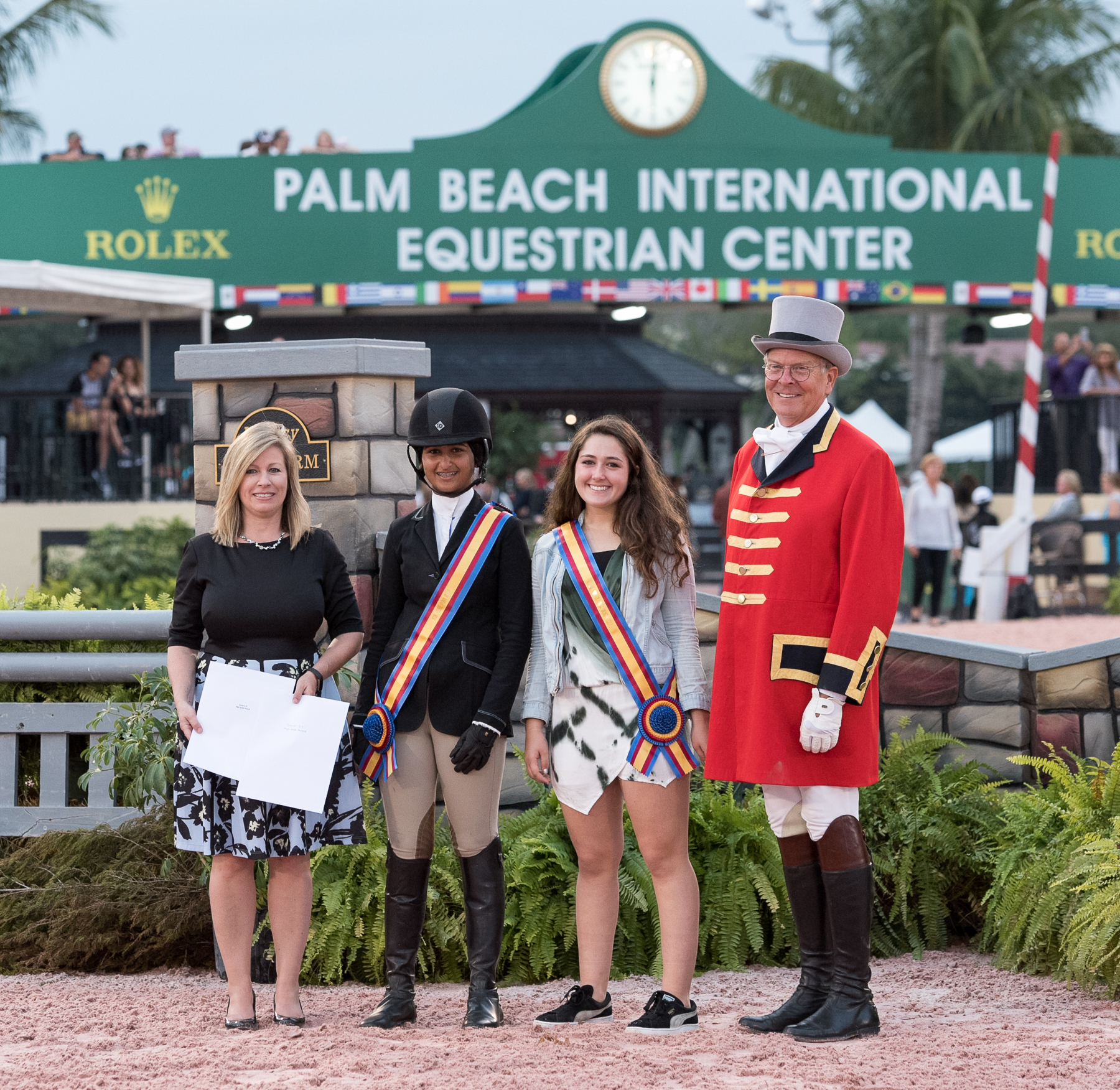 Elly Ficca, second from right, tied for the 3'3" Junior Hunter High-Score Award with Isha Swani and received her award from the USHJA's Marla Holt and ringmaster Steve Rector.