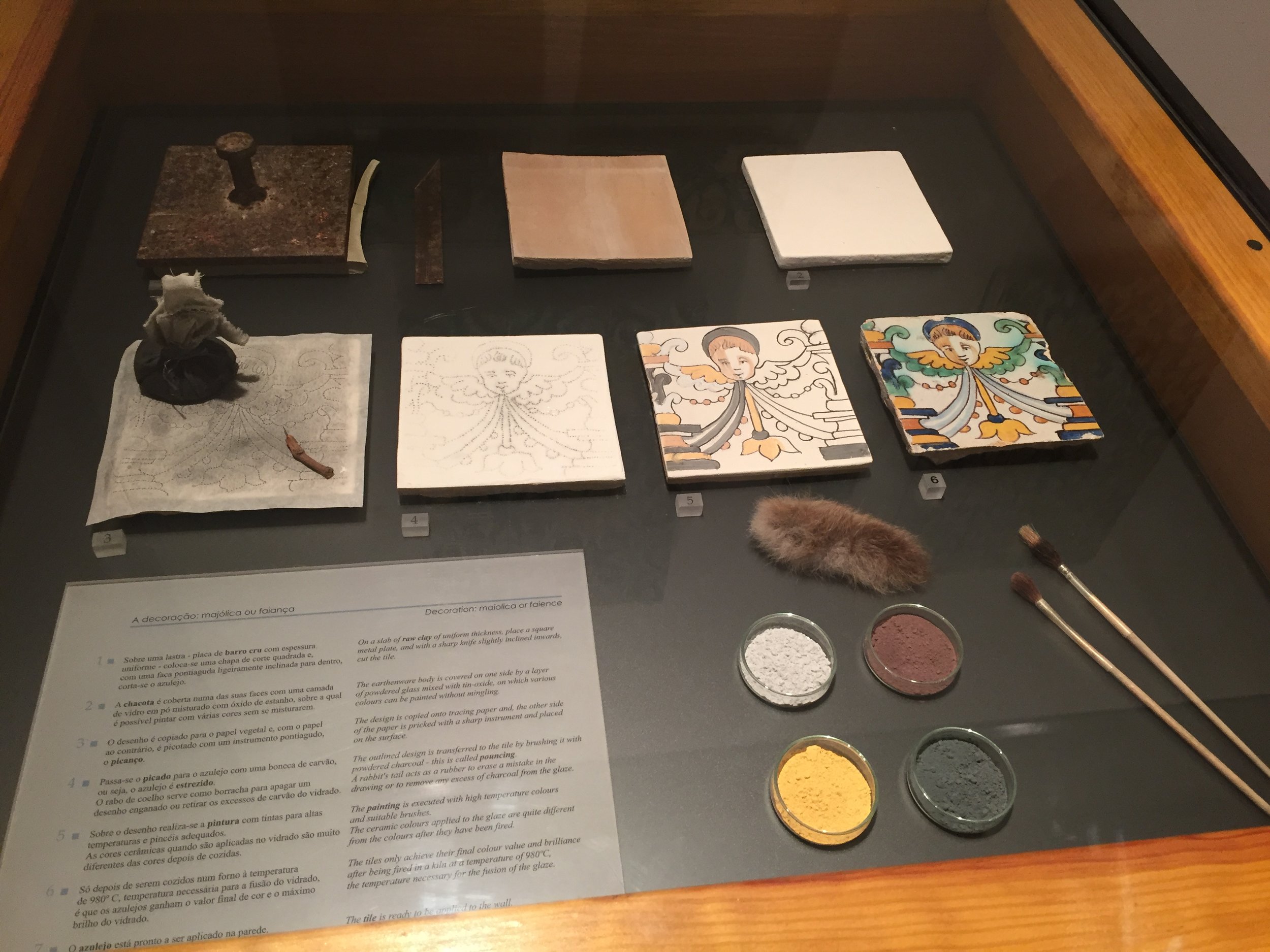 Display in the Museo do Azulejos illustrating the process of creating an image on a tile.