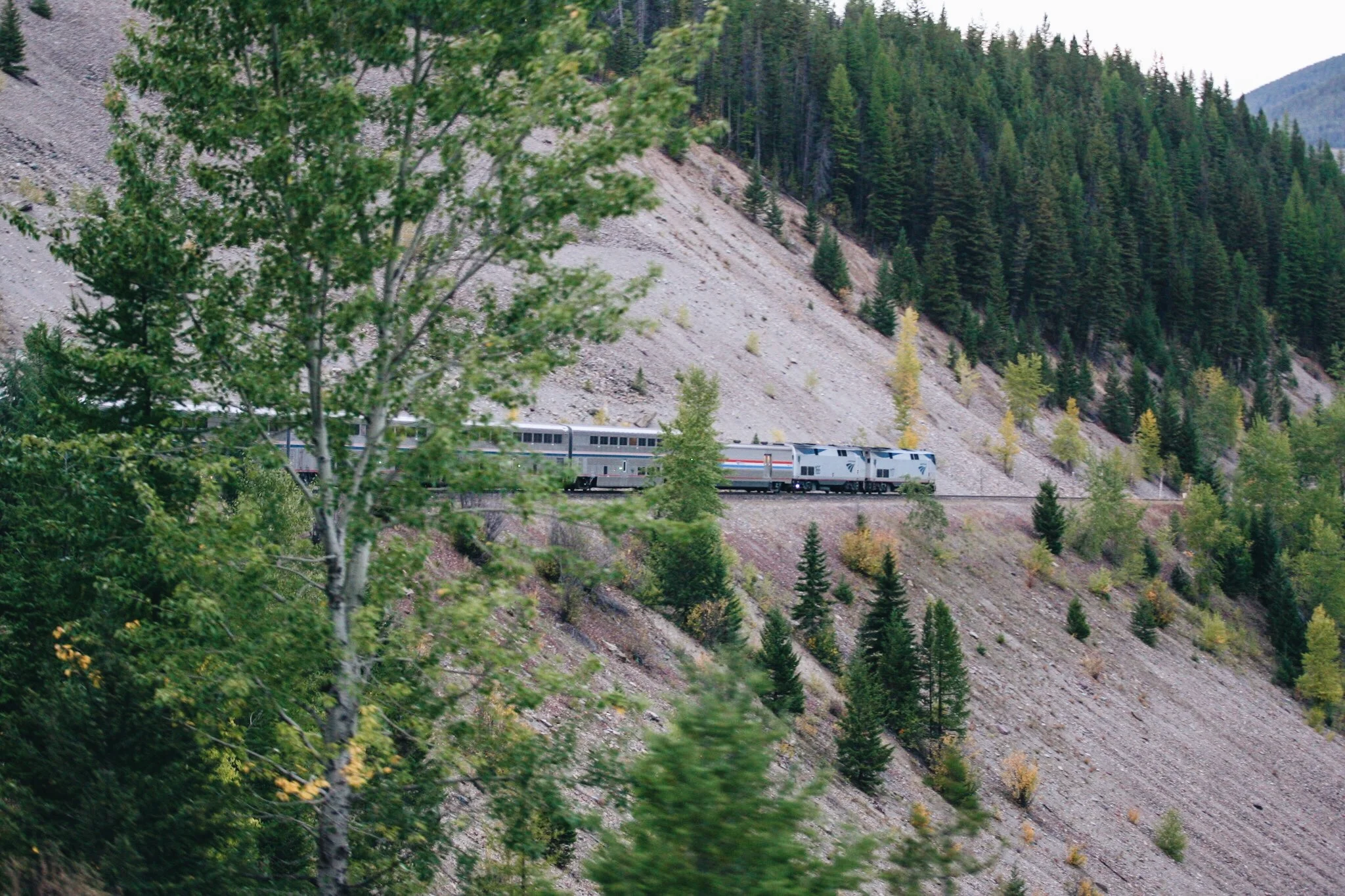 Amtrak's The Empire Builder snakes around mountains near Browning, MT - September 2015