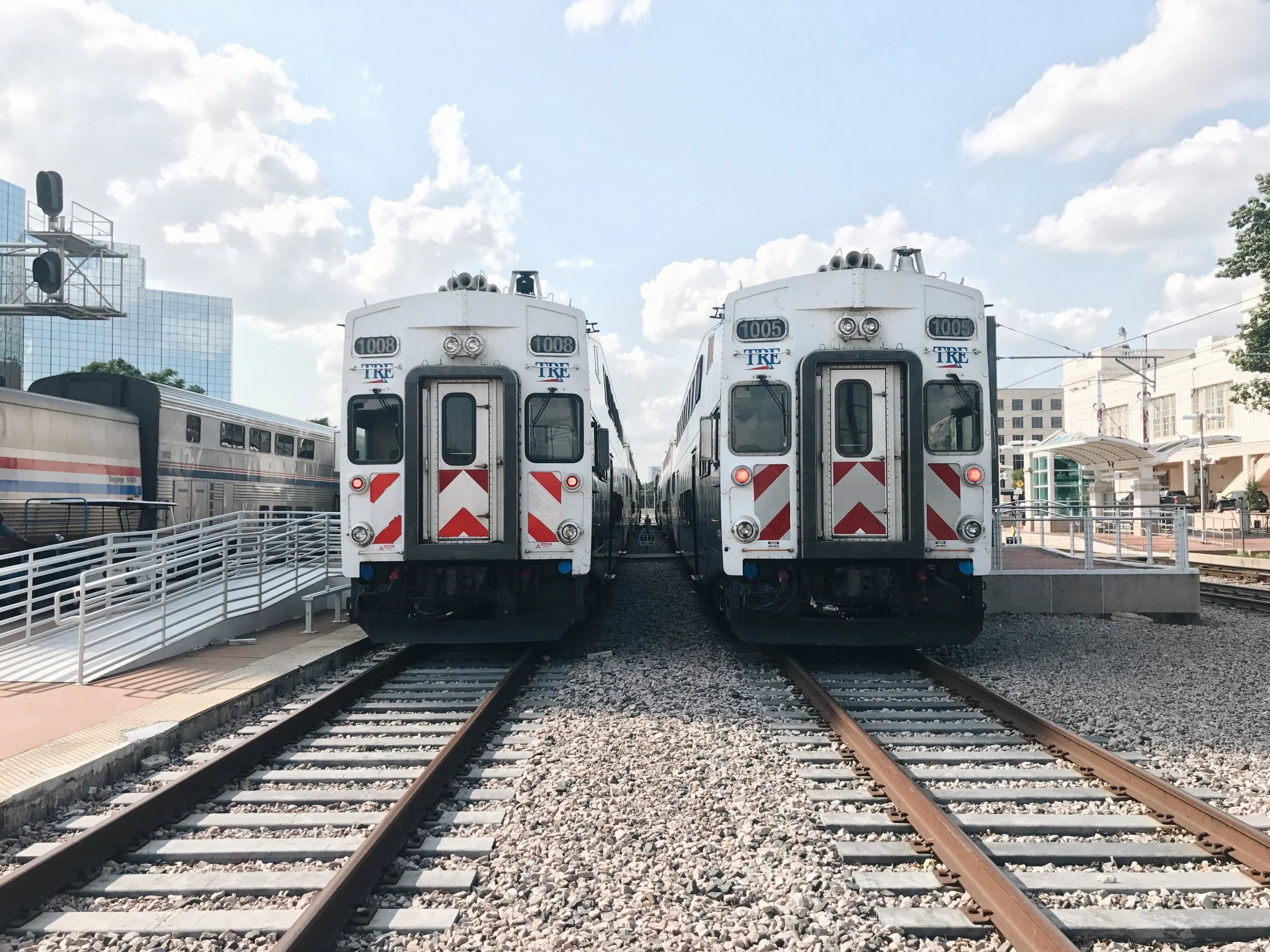 Two afternoon Trinity Railway Express trains board passengers on the platform in Dallas