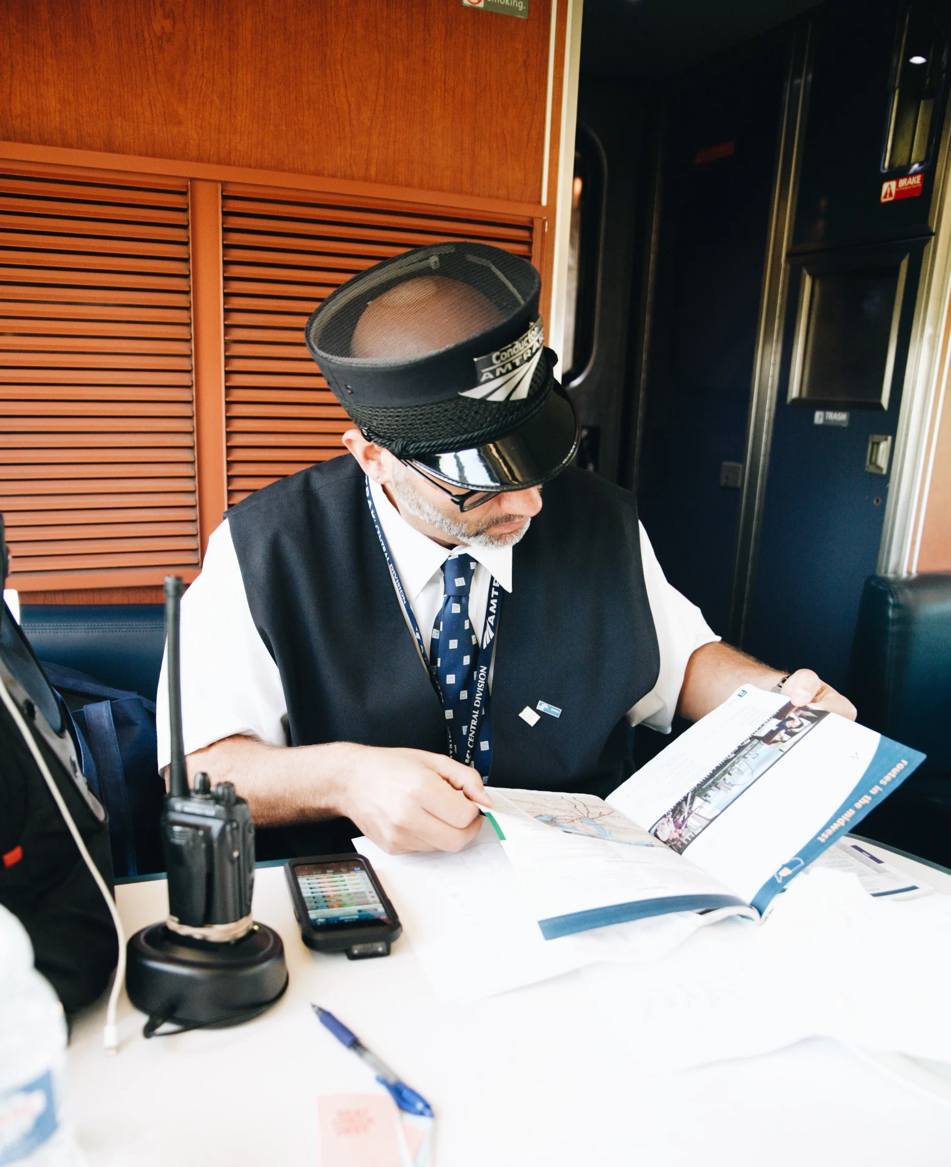 John checks train maps to find a way to connect passengers with the trains they will miss in Chicago.&nbsp;