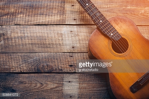 Acoustic guitar on wooden background
