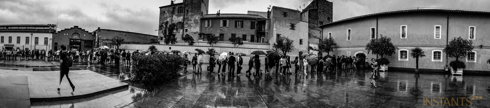 Perpignan, France - 08.09.2013 : Sous la pluie, people waiting in line to enter the main exhibition @ Couvent des Minimes. 