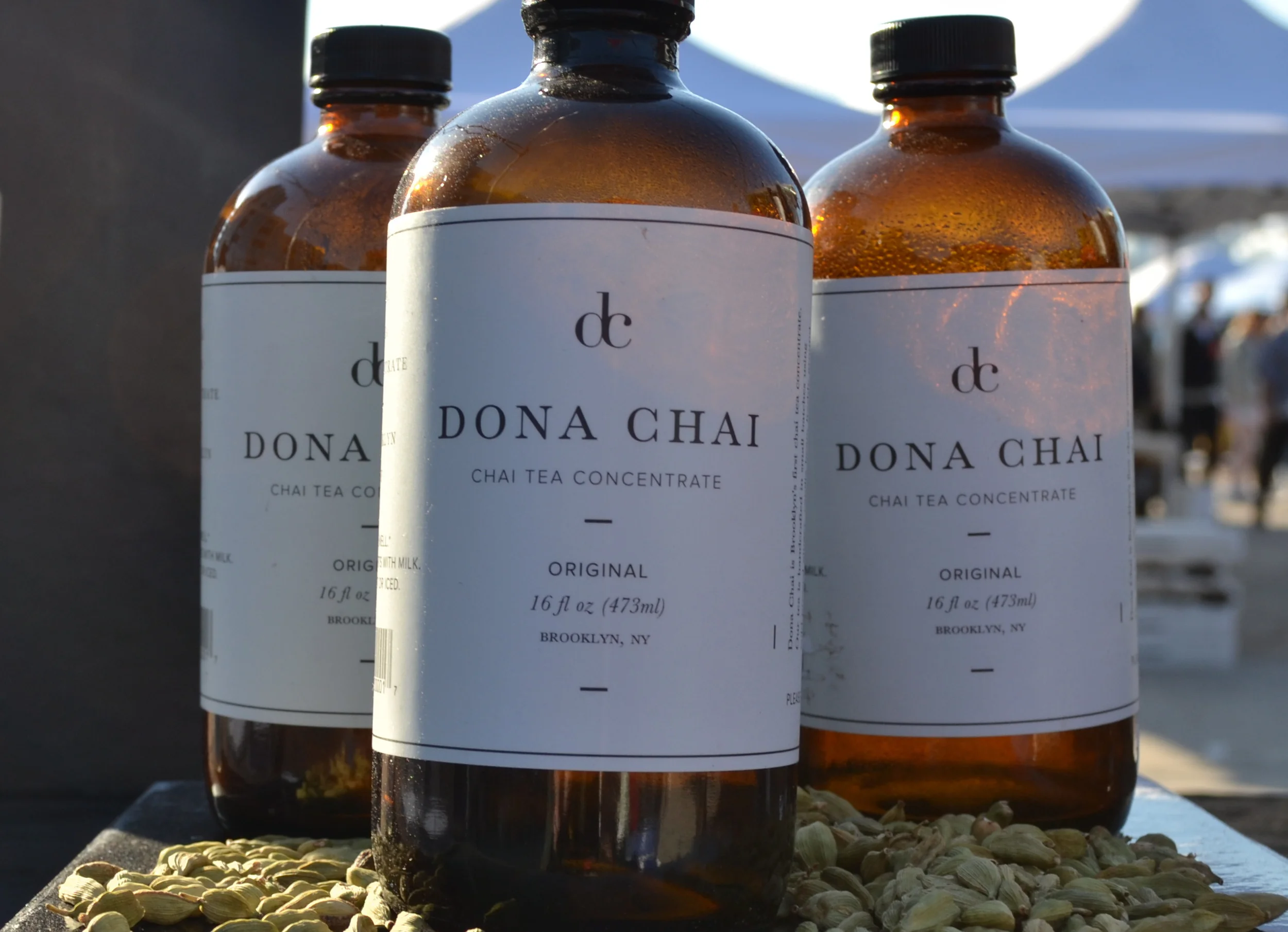 Almond milk iced chai latte for now, bottles of Dona Chai chai tea concentrate for later.