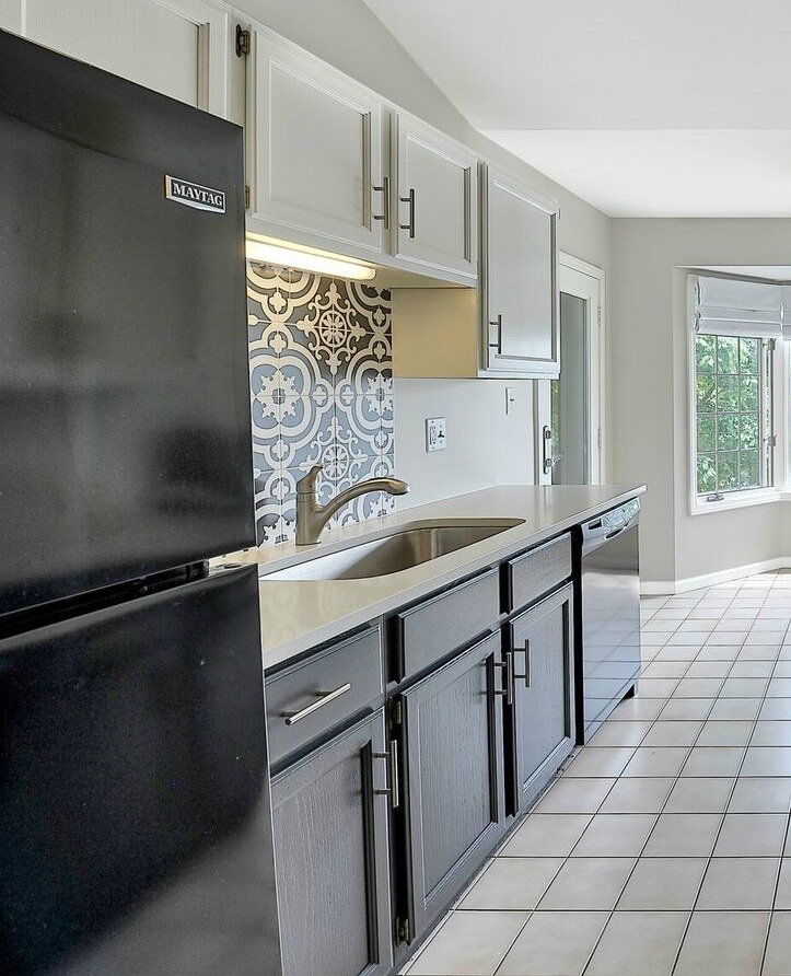HIGH-END details - Added fun, black and white concrete tile back splash behind the sink area. Which pulls all of the elements of the room together.