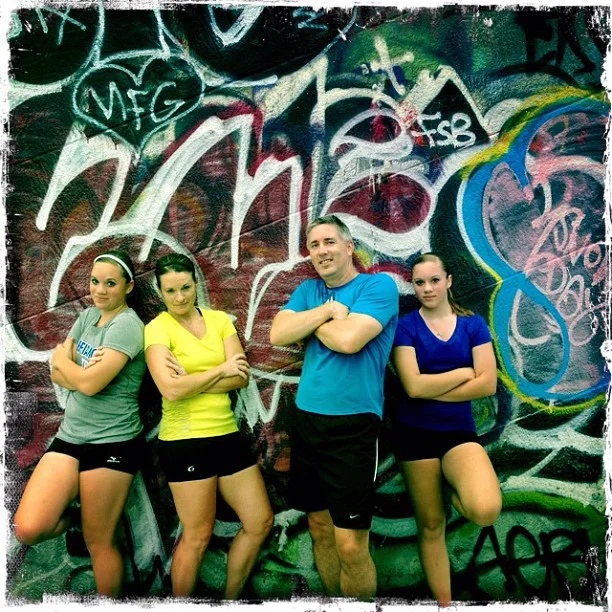 This family of runners stops for a photo in front of some of great graffiti art on the Manhattan Bridge on a New York City Personalized sightrunning tour.