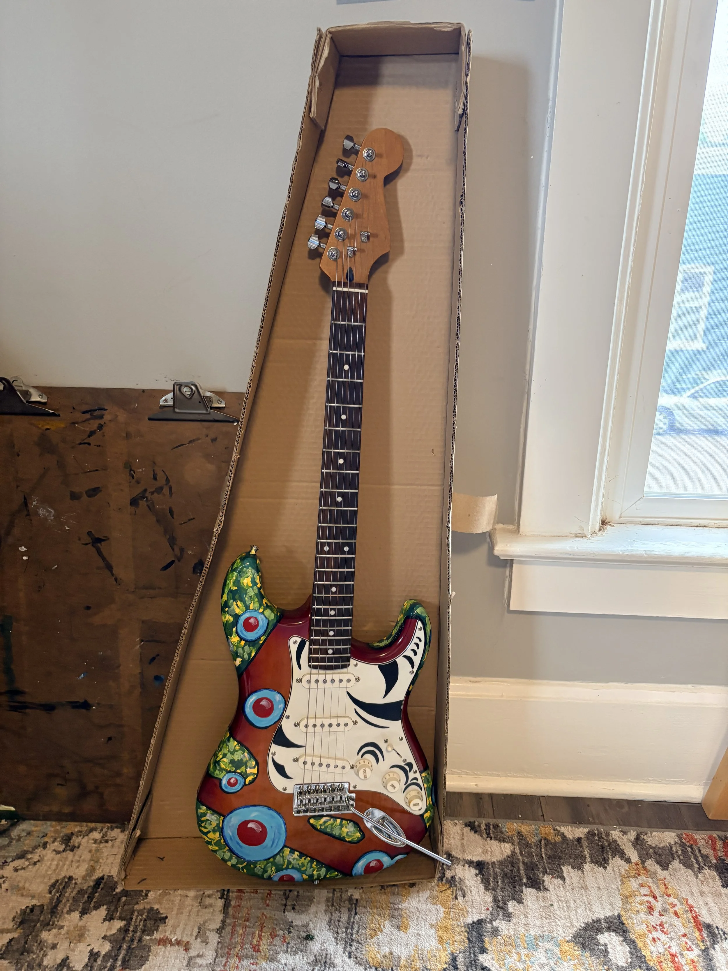  This is the front of a guitar I painted at the request of Off The Hook Arts in Fort Collins, CO.   9 local artists painted 9 donated guitars that were auctioned off to support the organization. 