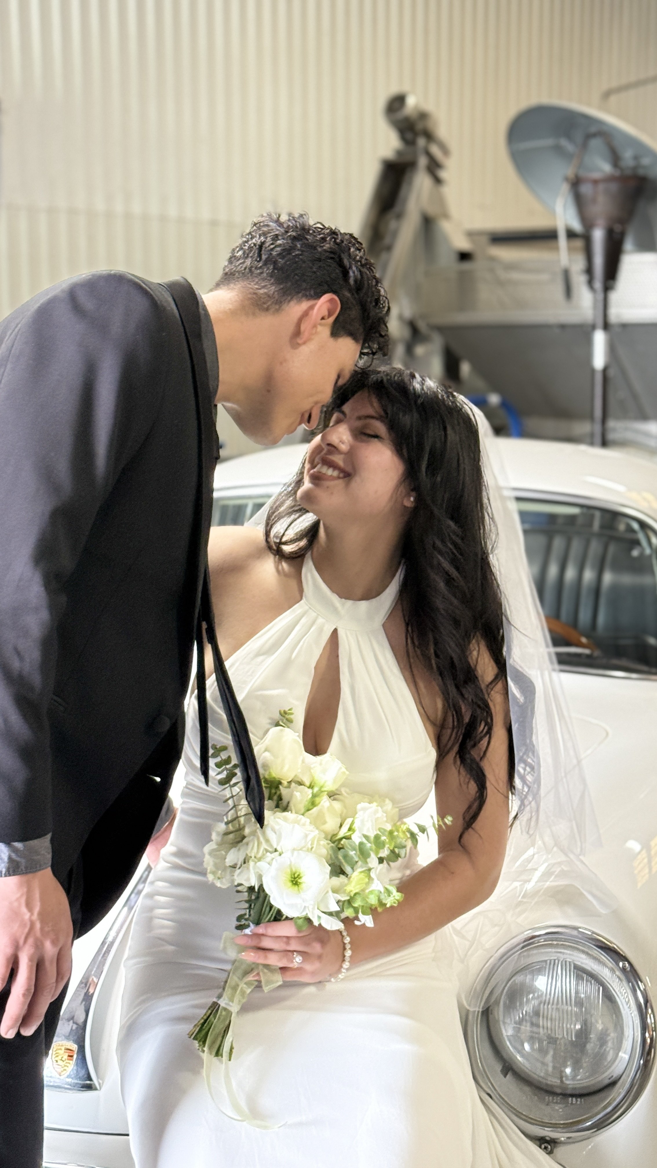 newlyweds sitting on porsche.JPG